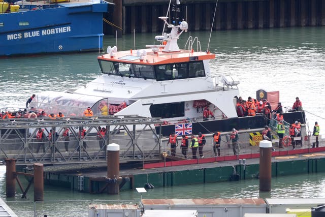 A group of people thought to be migrants are brought in to Dover (PA)