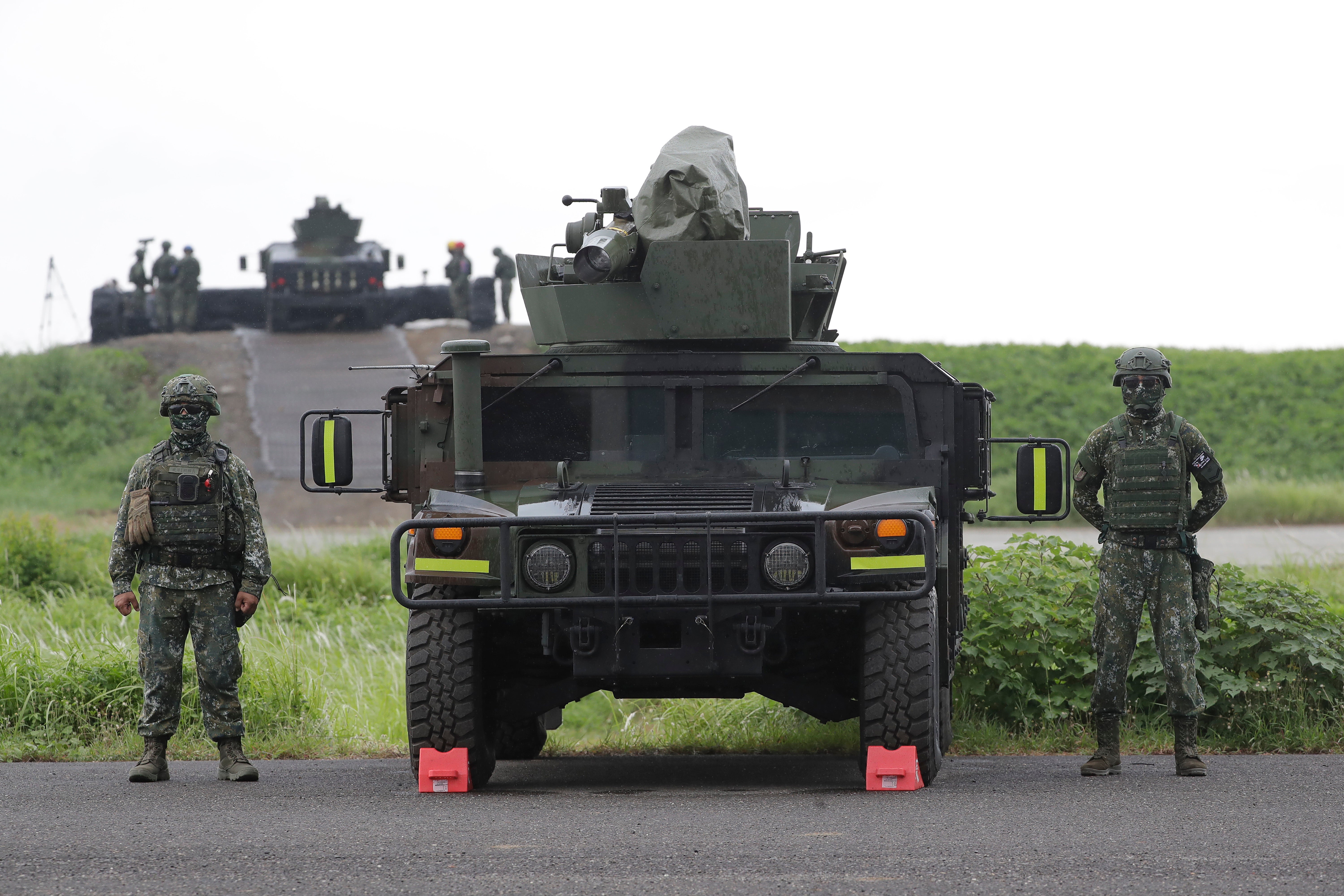 Soldiers basal   beside a M1167 HMMWV (High Mobility Multipurpose Wheeled Vehicle) anti-tank rocket  carriers during subject   drills successful  Taiwan