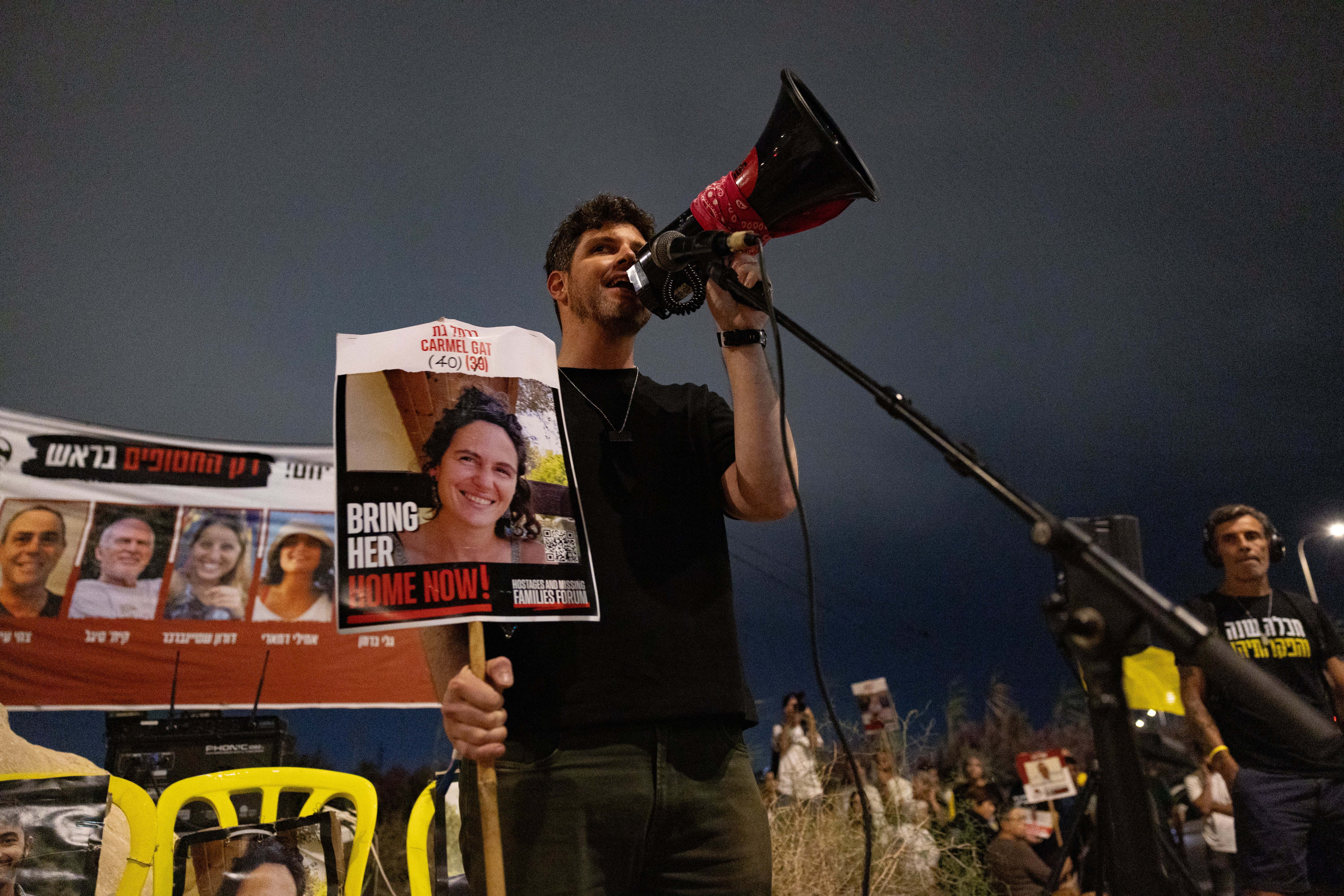 Gil Dickmann speaks about his cousin Carmel Gat, 41 at a rally in southern Israel on 5 October