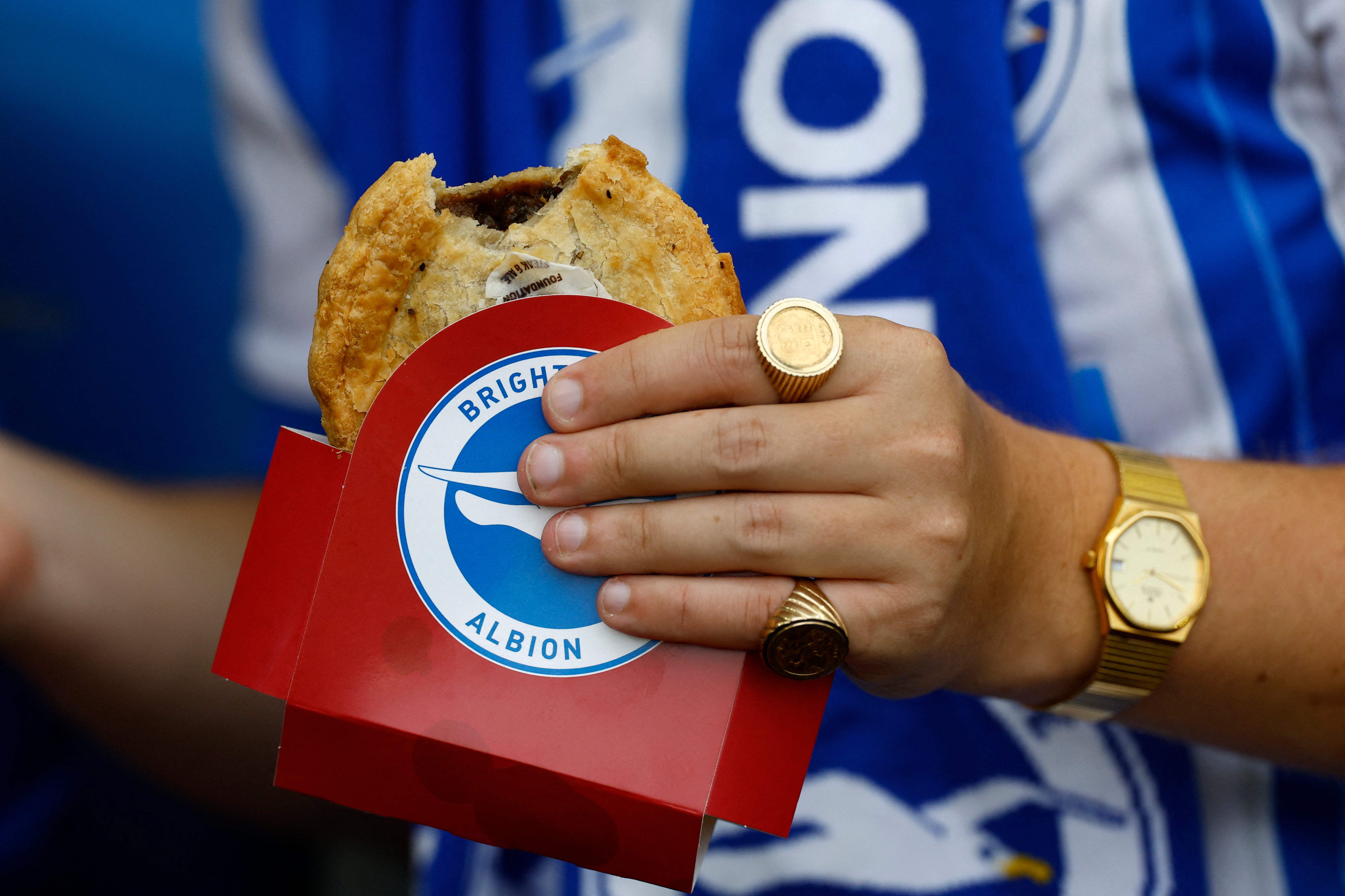 A Brighton fan warms up before kick-off