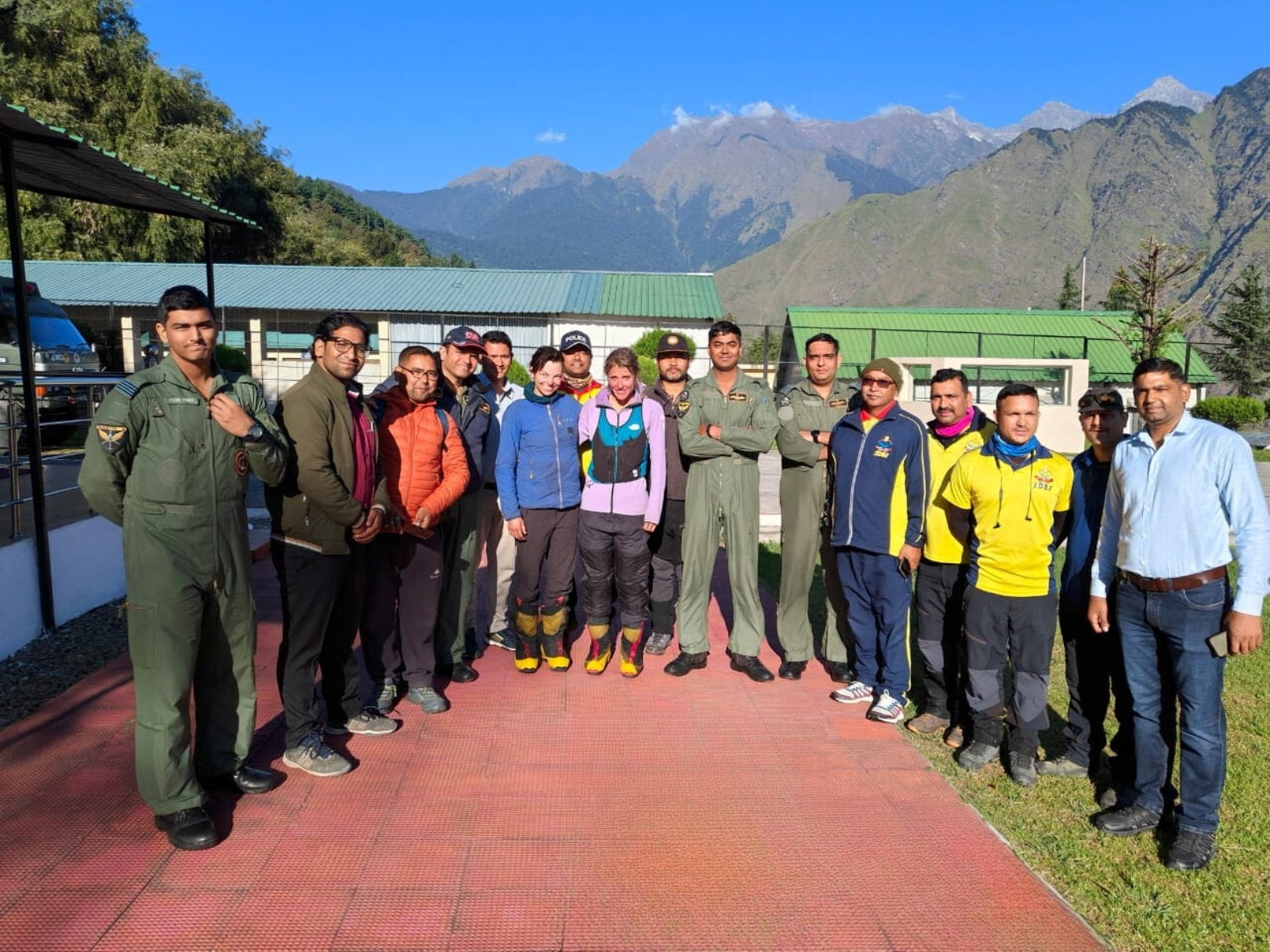 The rescued British and US climbers pose for a photo with rescuers in Joshimath, Uttarakhand, India