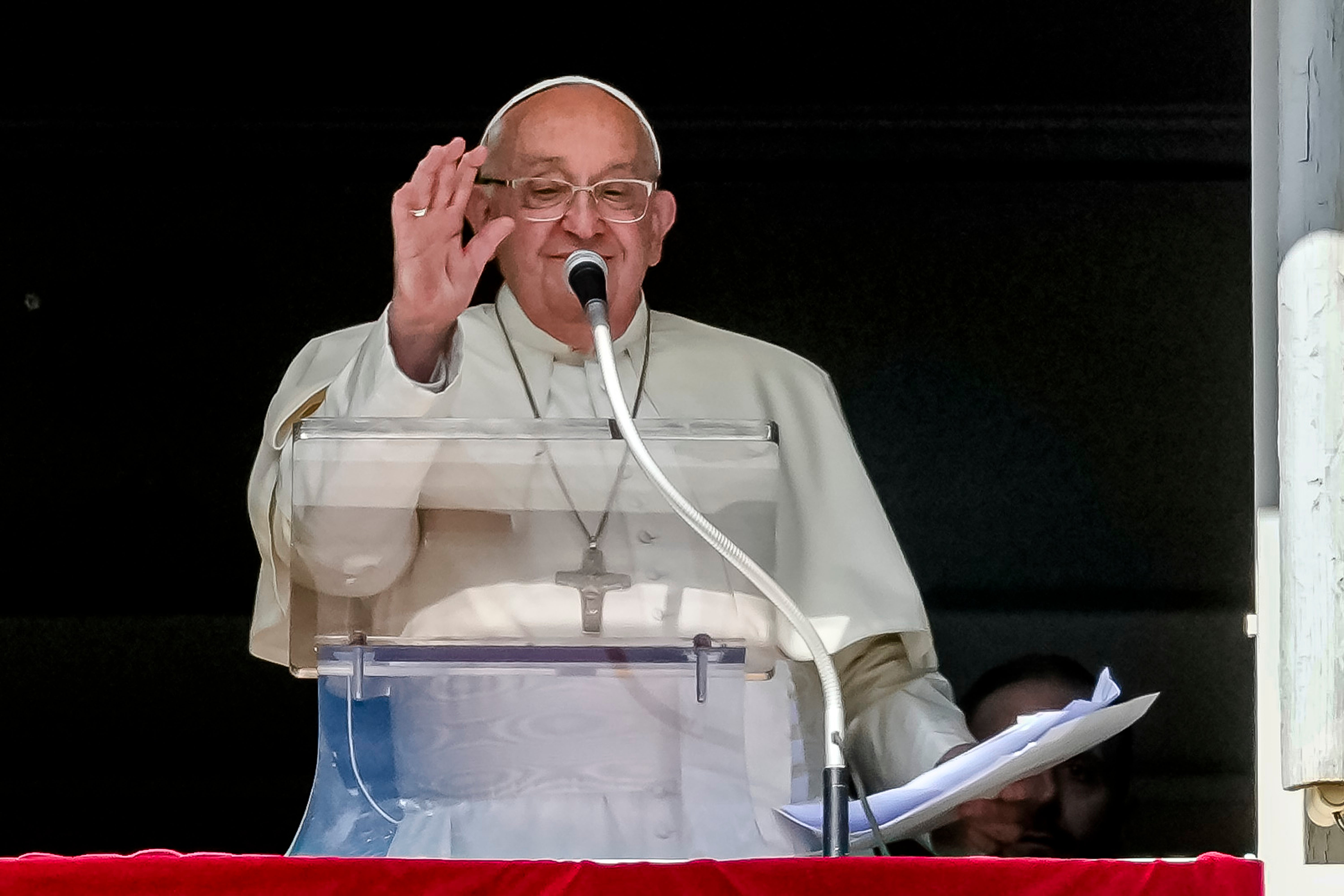 Pope Francis appears at his studio window for the traditional noon blessing of faithful and pilgrims