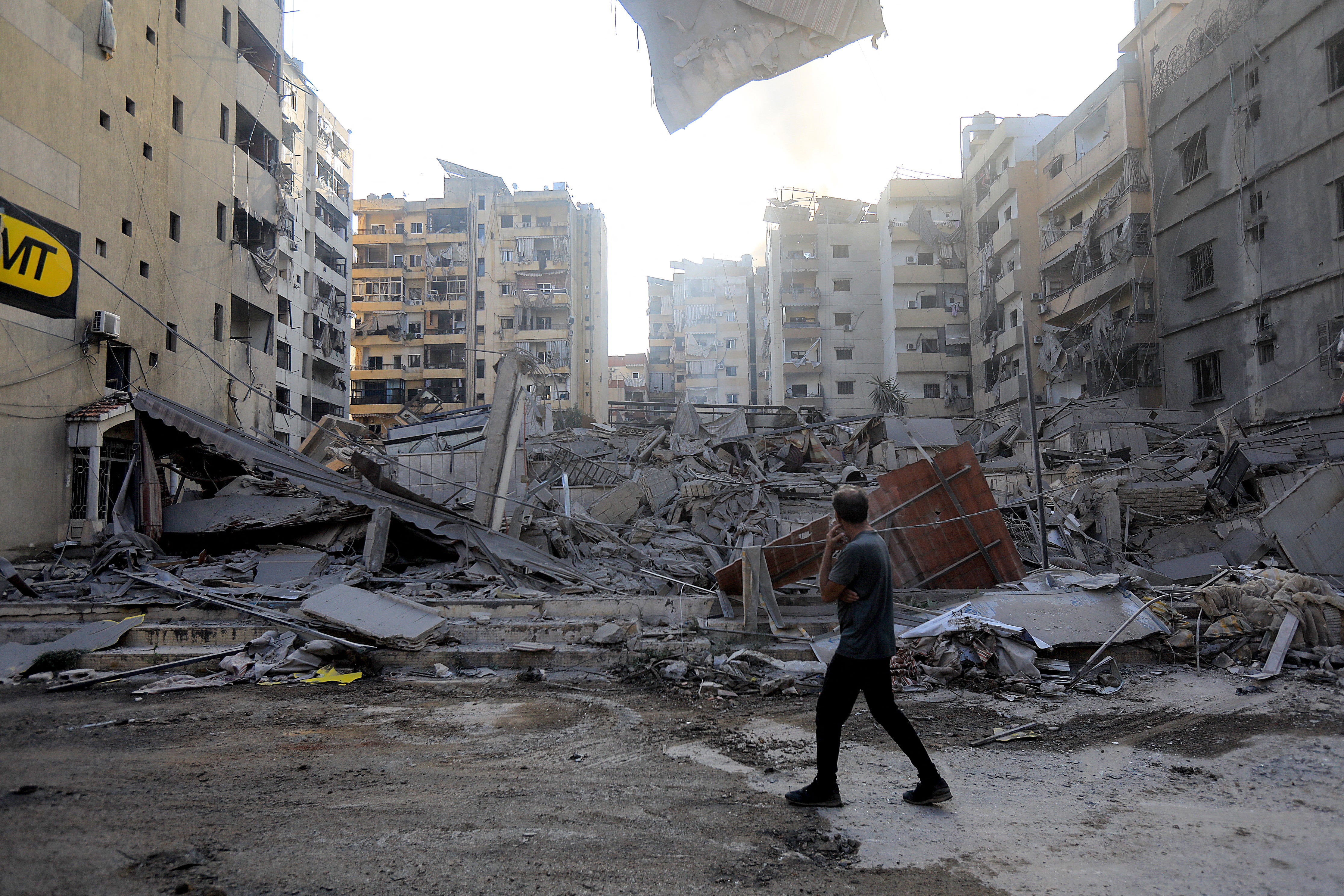 A man stares at the devastation in the aftermath of an Israeli strike that targeted the Sfeir neighbourhood in Beirut's southern suburbs