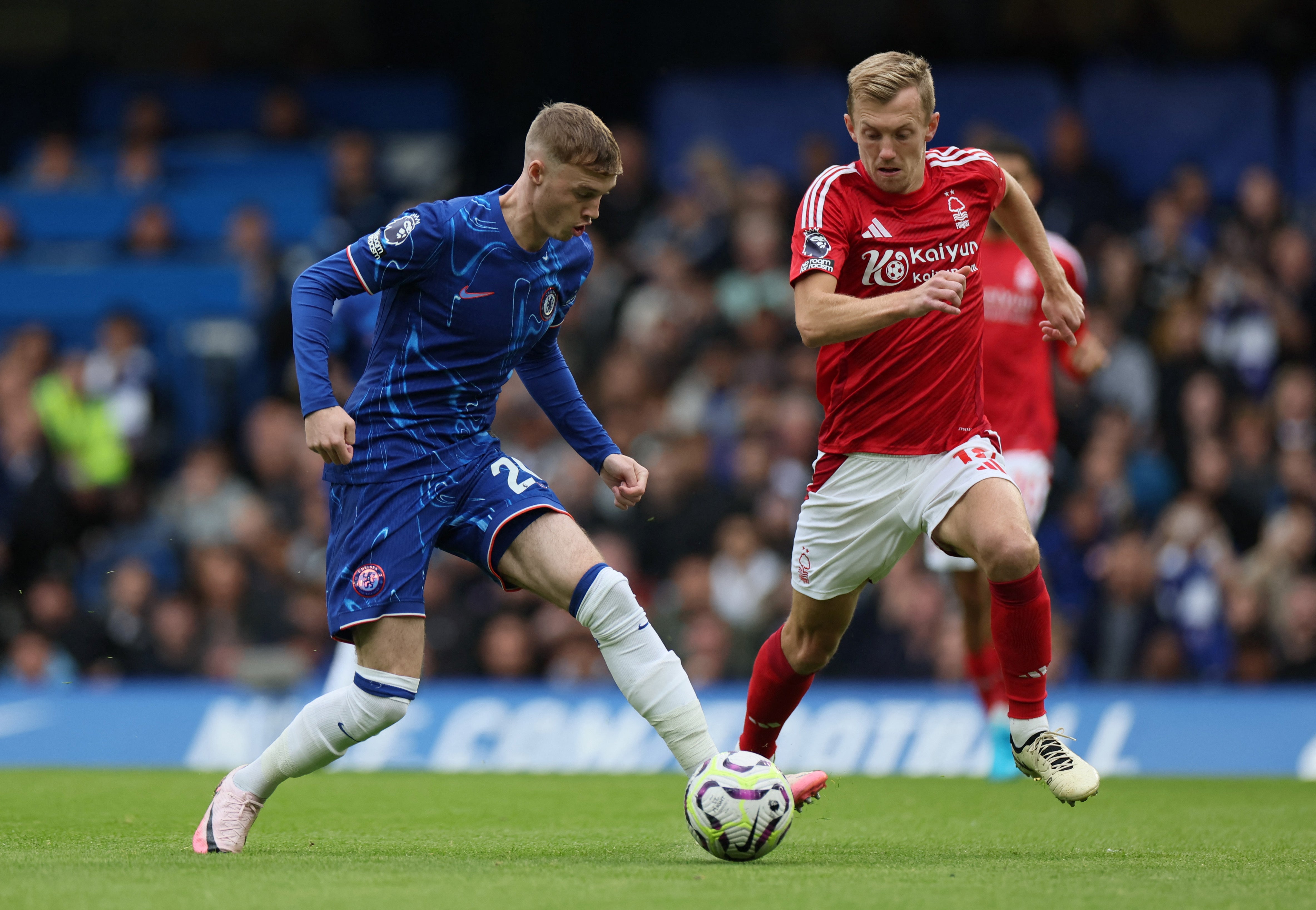 Cole Palmer gets on the ball as James Ward-Prowse gives chase