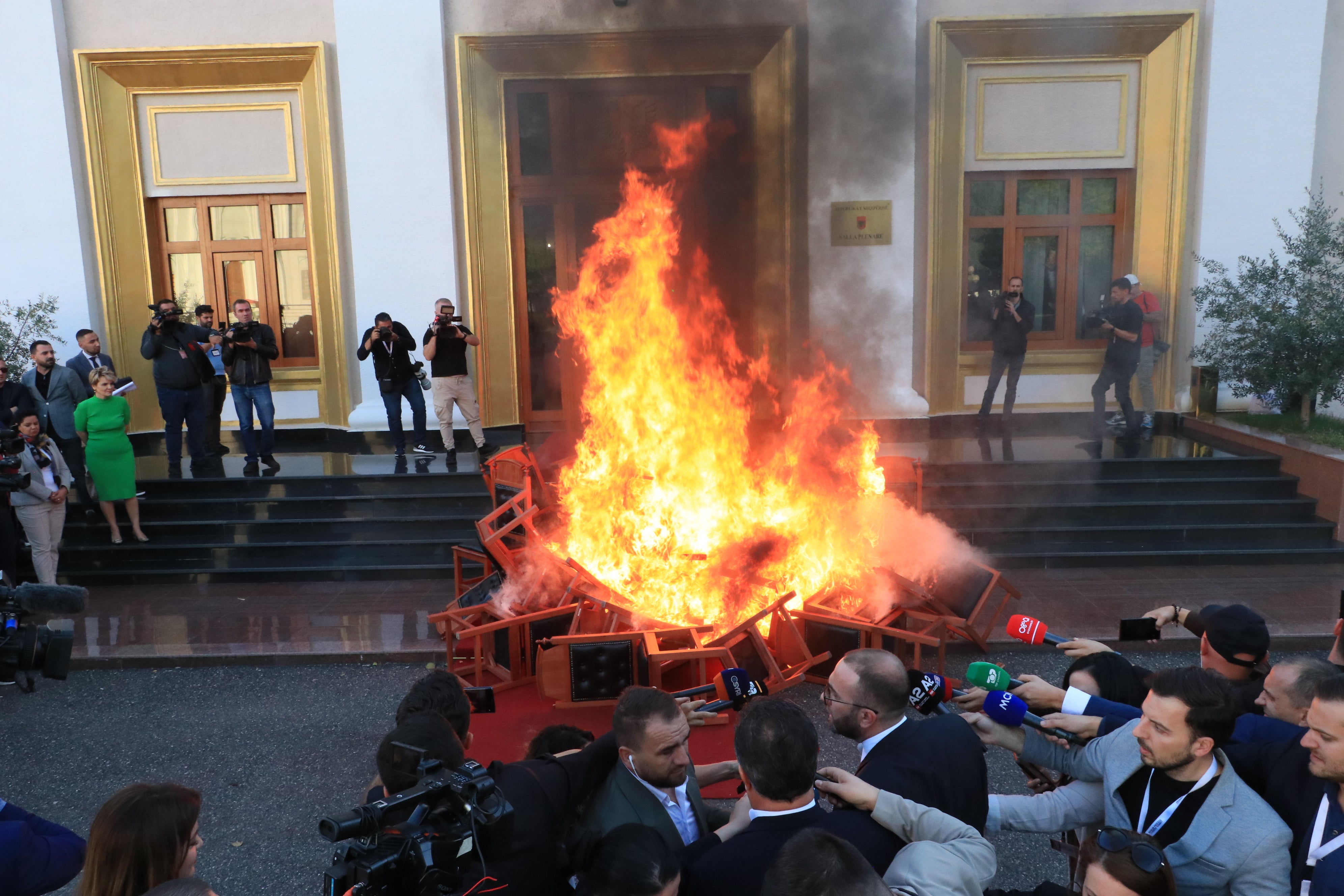 Opposition members of parliament set fire to their chairs outside the parliament building, following a brawl during a session of the Albanian Parliament, on 30 September 2024