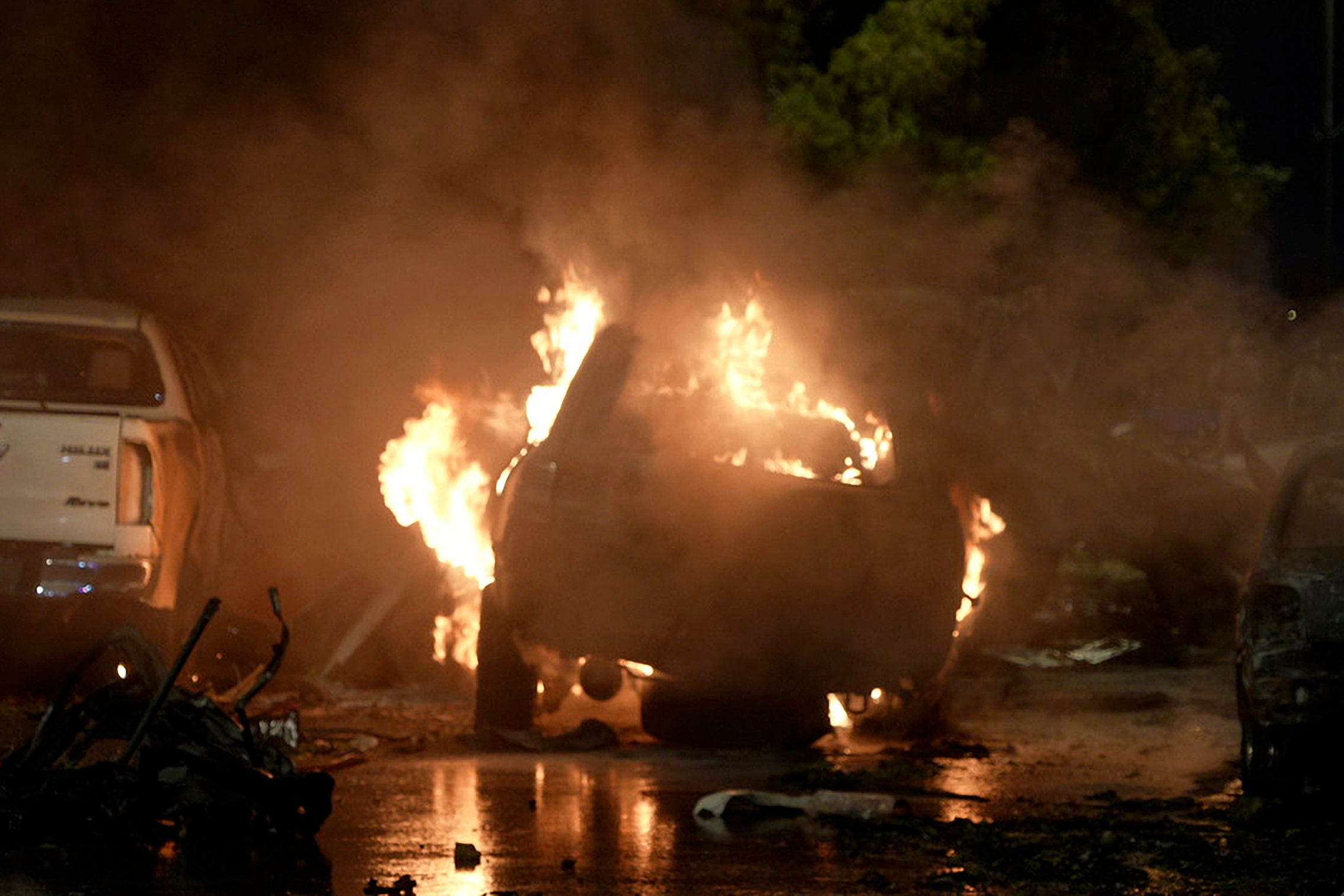 A vehicle is seen on fire at the site of an explosion outside the Karachi airport in Pakistan