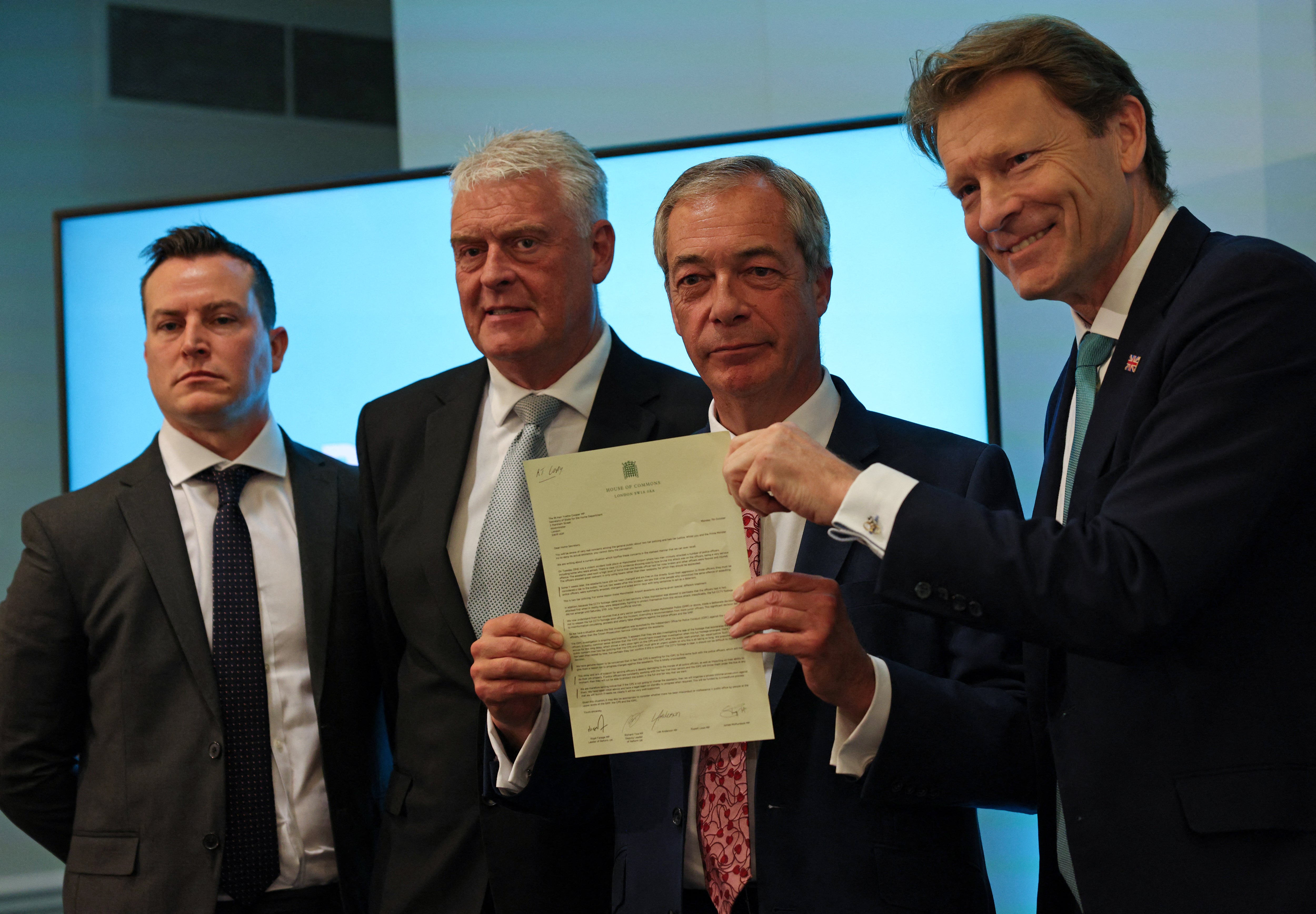 Leader of Reform UK, Nigel Farage, and fellow MPs, James Murdock, Lee Anderson and Richard Tice hold a letter addressed to Britain's Home Secretary, during a press conference