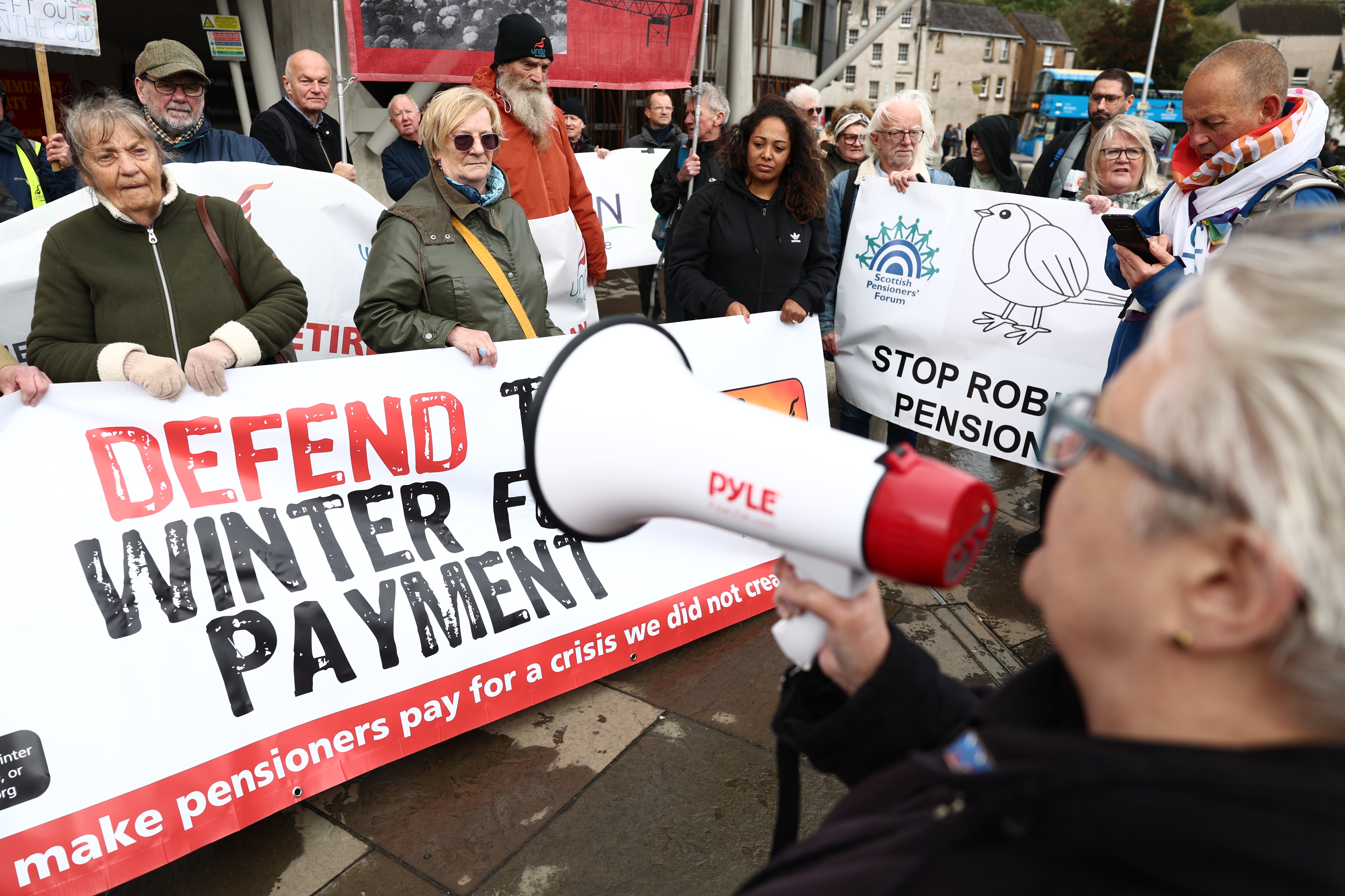 Protesters gather outside the Scottish Parliament to challenge the winter payment cuts