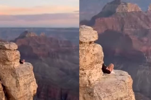 <p>The tourists were captured on camera sitting high above the drop </p>