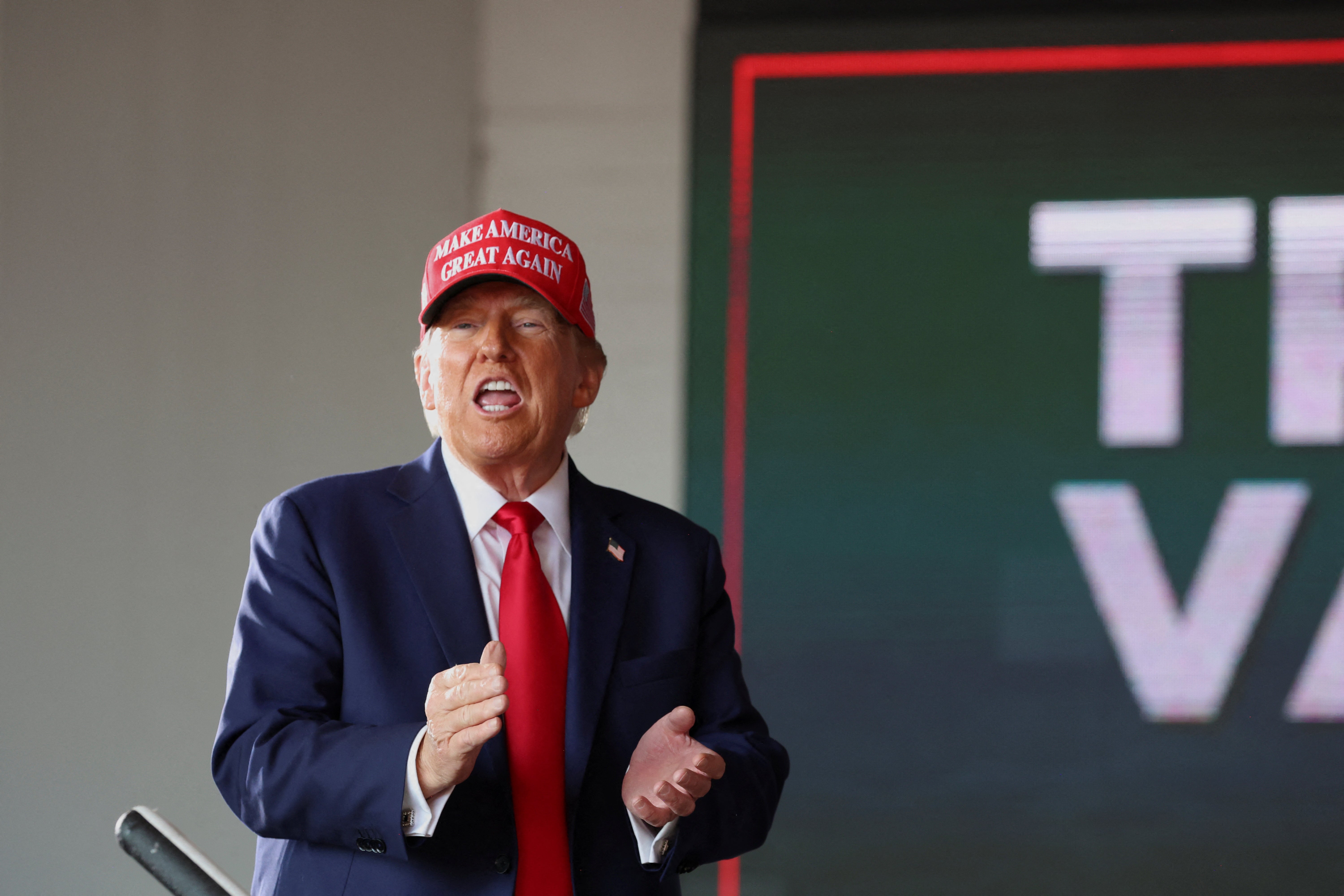 Trump claps at a campaign rally in Wisconsin on Sunday. Trump has falsely asserted that the Biden administration is “giving” nearly all of FEMA’s money to illegal migrants.