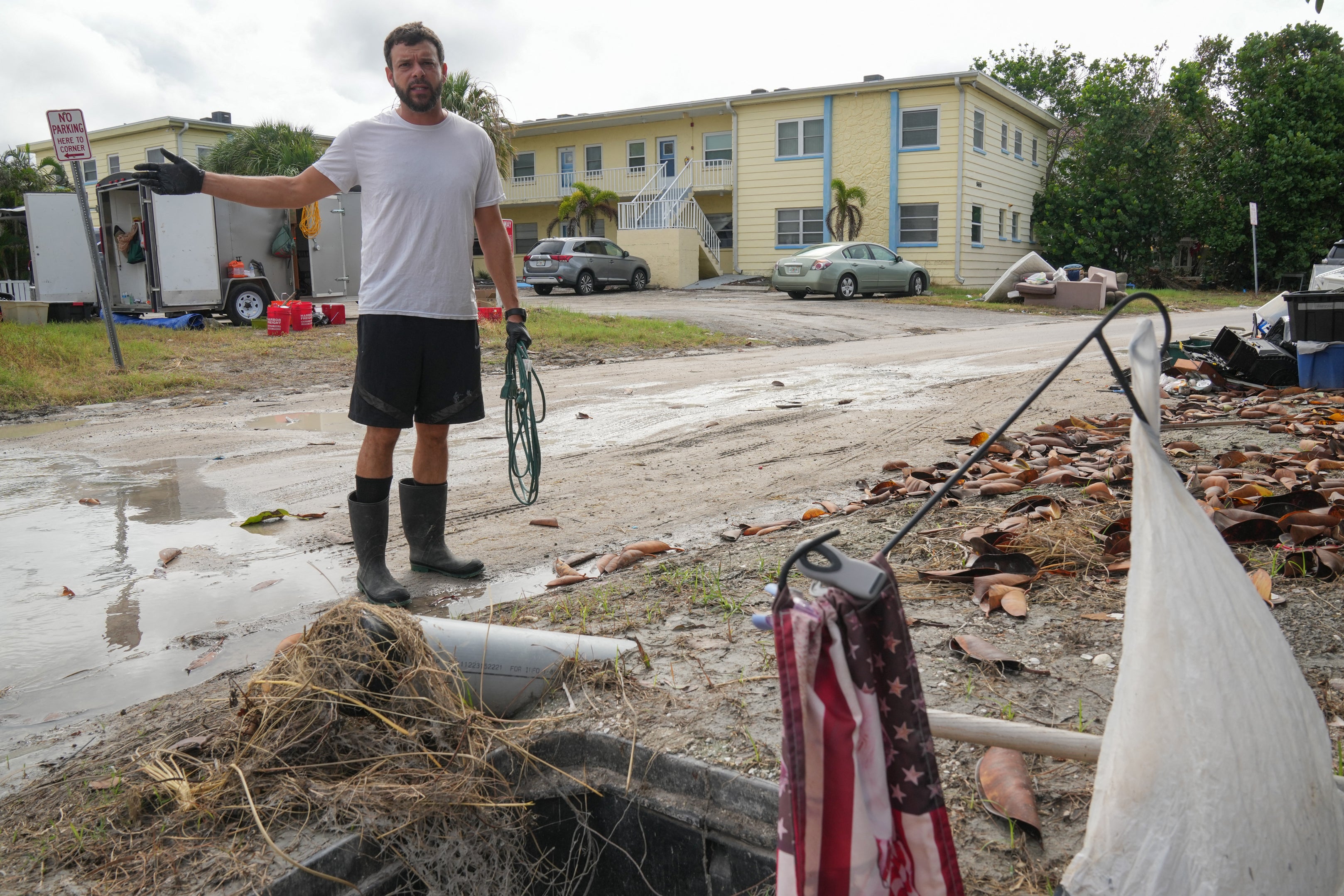 Dane Grifford clears debris left by Hurricane Helene ahead of Hurricane Milton's expected landfall