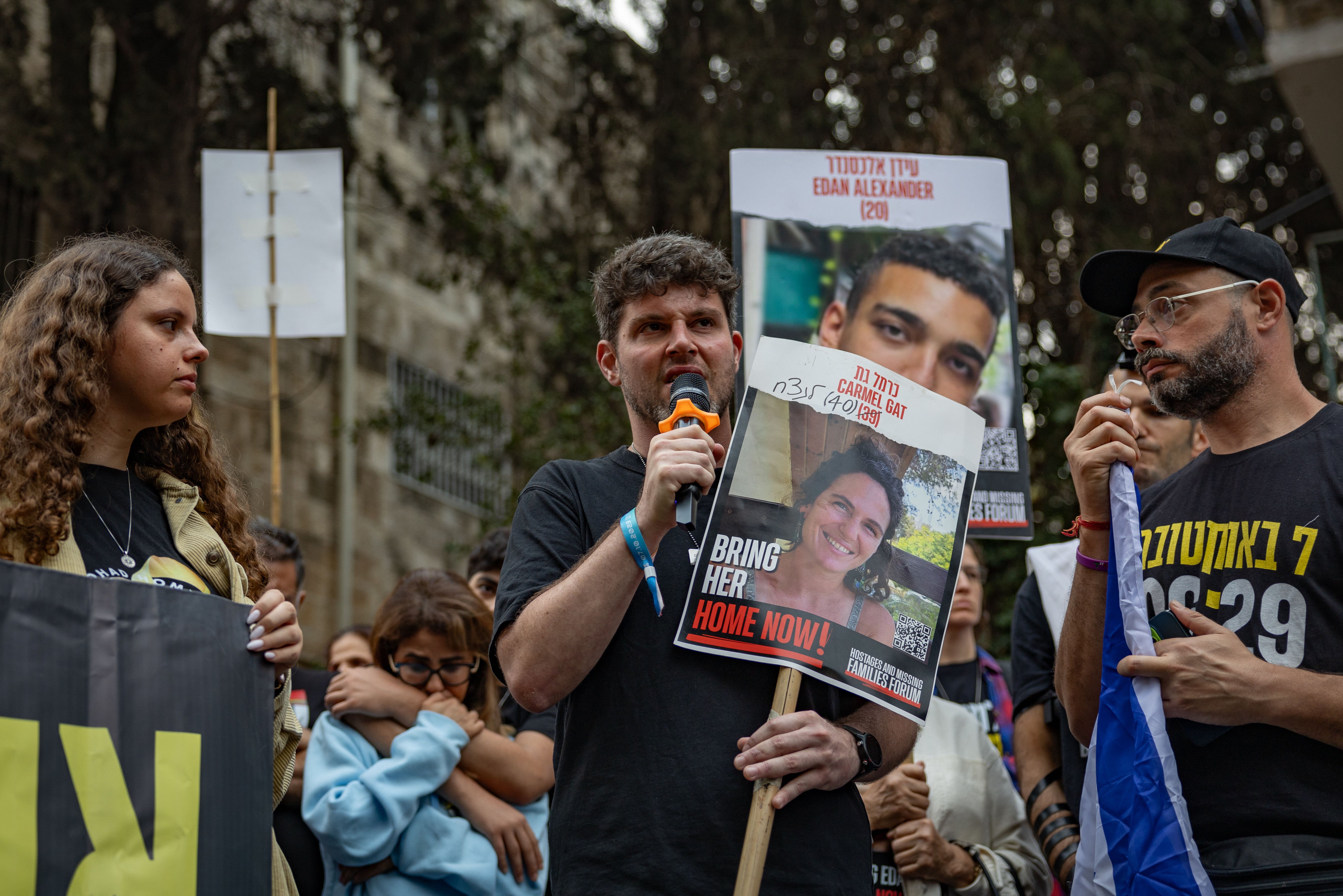 Gil Dickmann, centre, the cousin of killed hostage Carmel Gat, directly addressed Benjamin Netanyahu. The parents of Yulie Ben Ami, left, were also taken captive