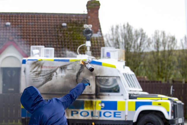 Youths throw petrol bombs at a PSNI vehicle ahead of a dissident Republican parade in the Creggan area of Londonderry (PA)