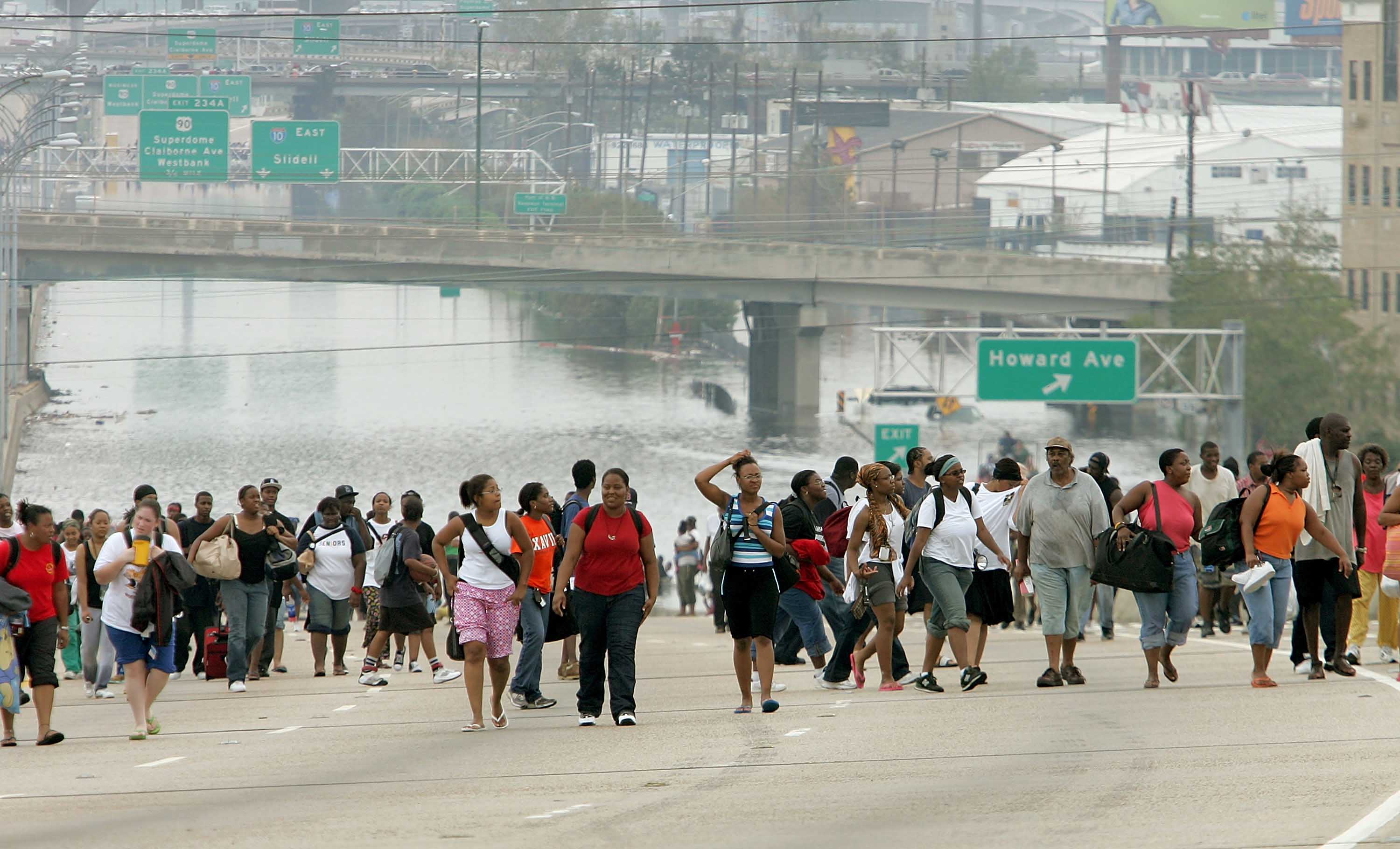 Survivors walk to high ground after Hurricane Katrina hits New Orleans, Louisiana, in 2005. While Katrina did not make landfall as a Category 5 storm, it brought staggering damage and loss of life to the area.