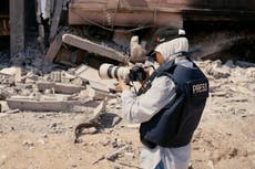 Wife of journalist killed in Gaza wears husband’s press vest as she continues his work