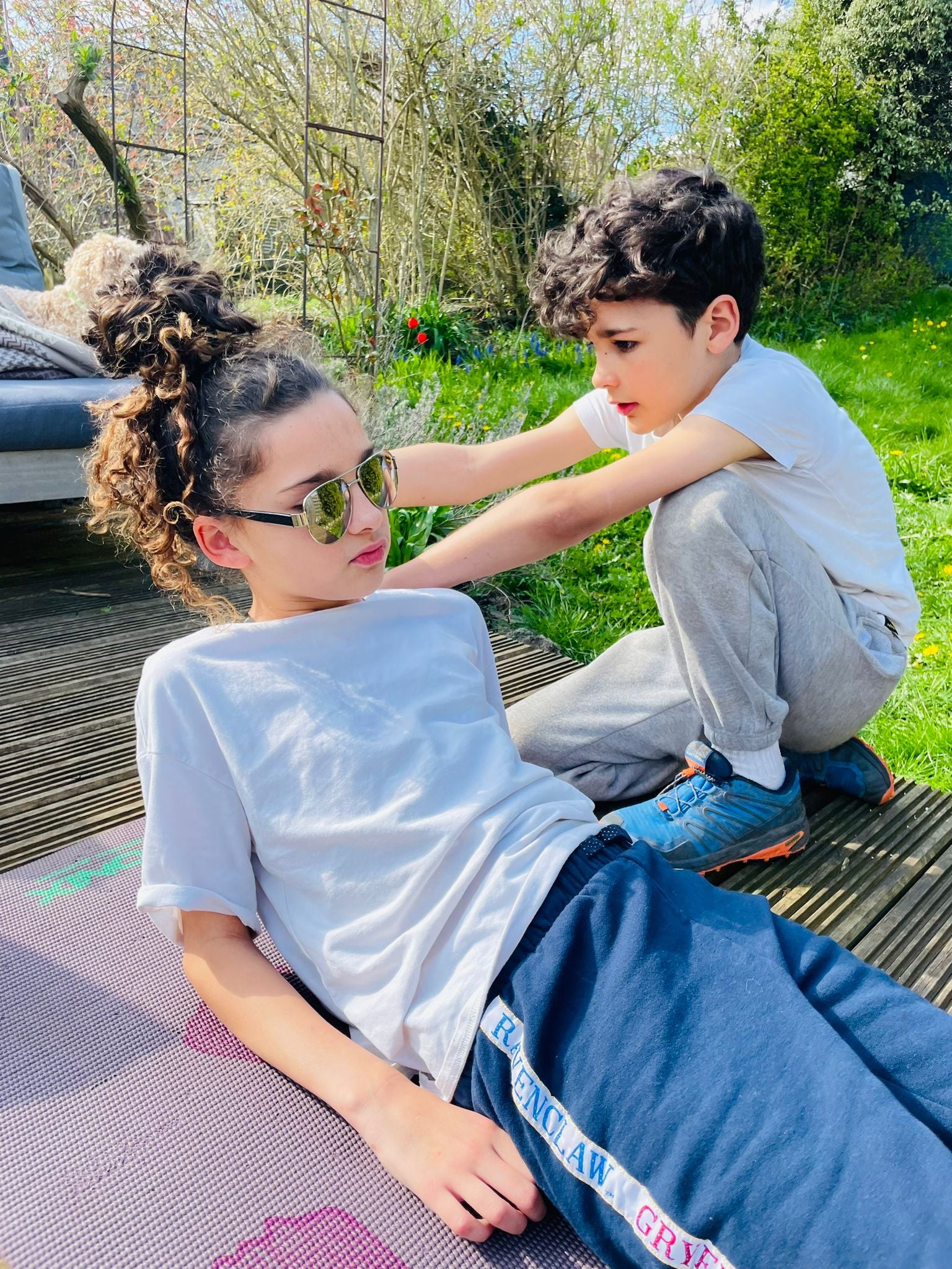 Amelie’s supportive younger brother Arlo helping her with physio exercises