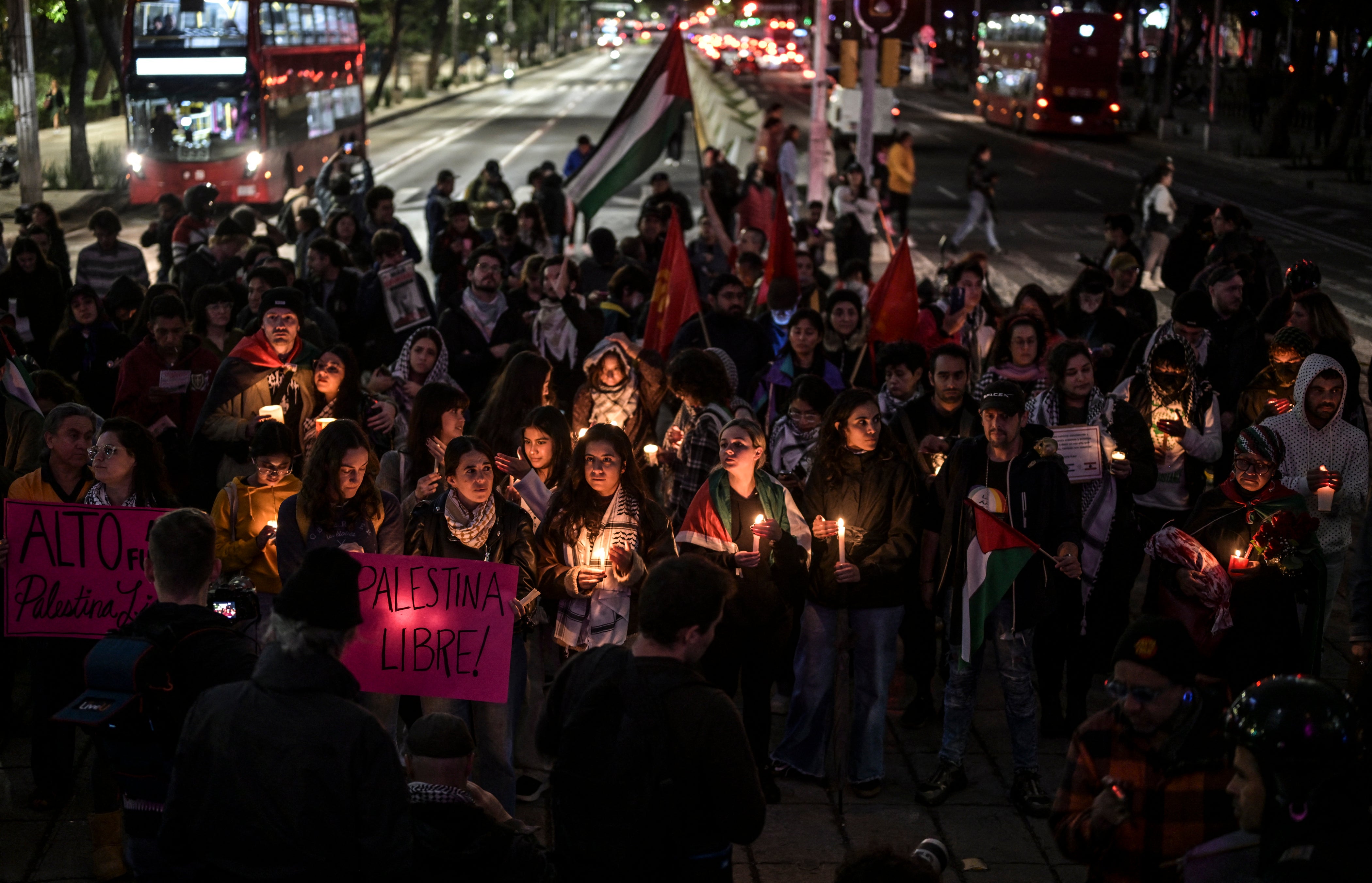 Pro-Palestine activists light candles as they take part in a vigil within the framework of the first anniversary of the Israel-Hamas conflict in Mexico