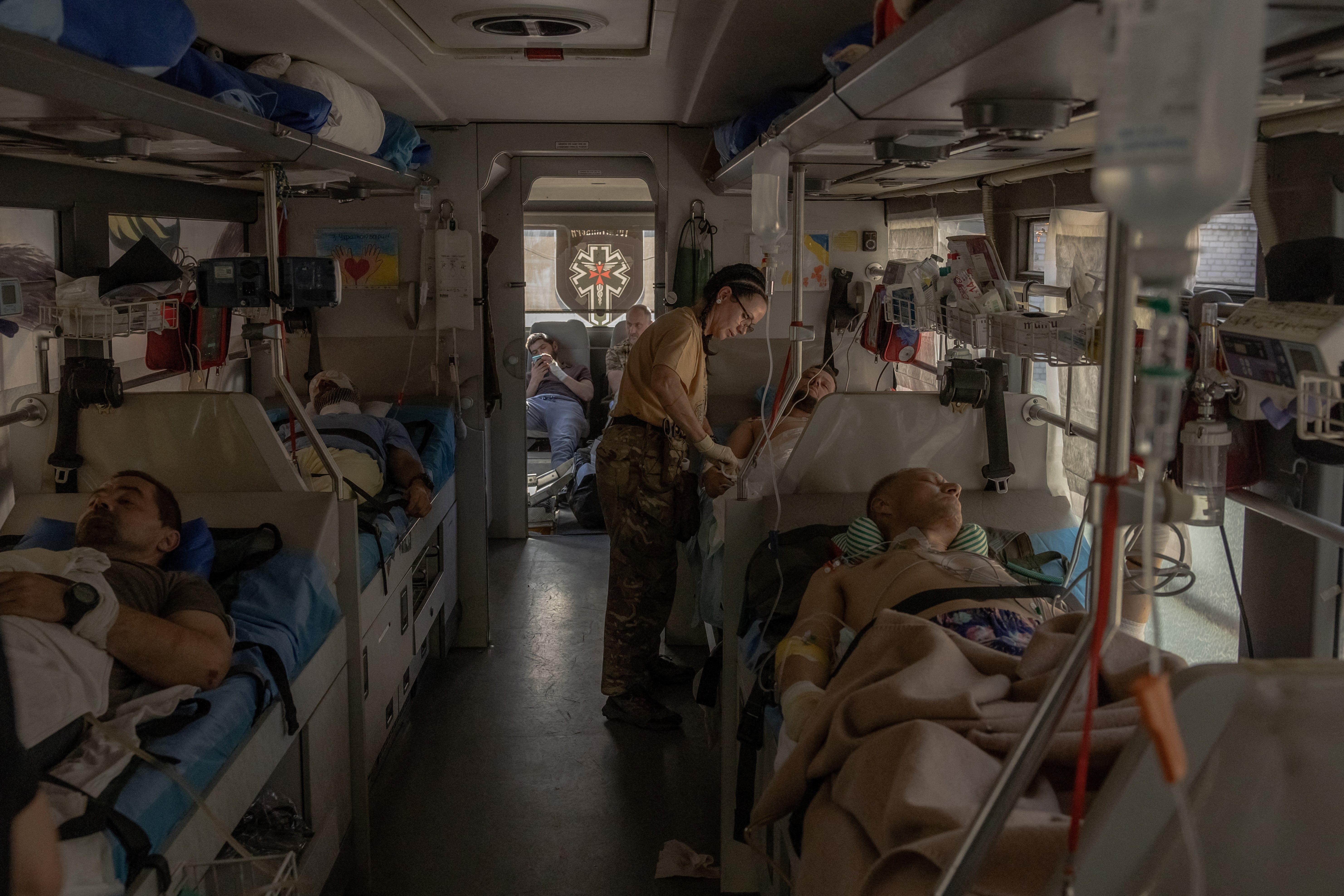 Paramedics of the volunteer medical battalion Hospitallers treat Ukrainian servicemen wounded in fighting in the Donetsk region