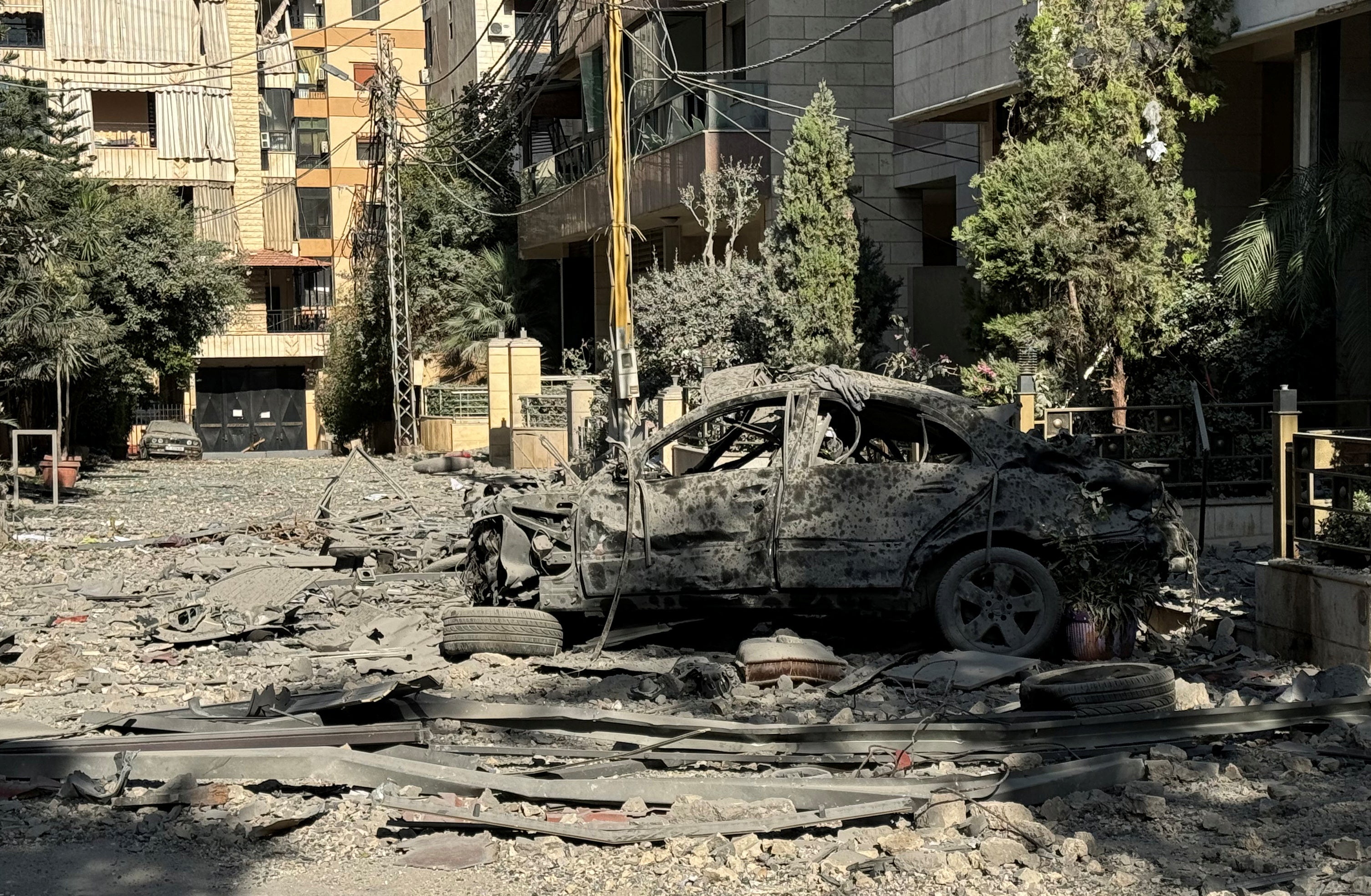 The burnt out shell of car remains on a street in southern Beirut after overnight Israeli airstrikes