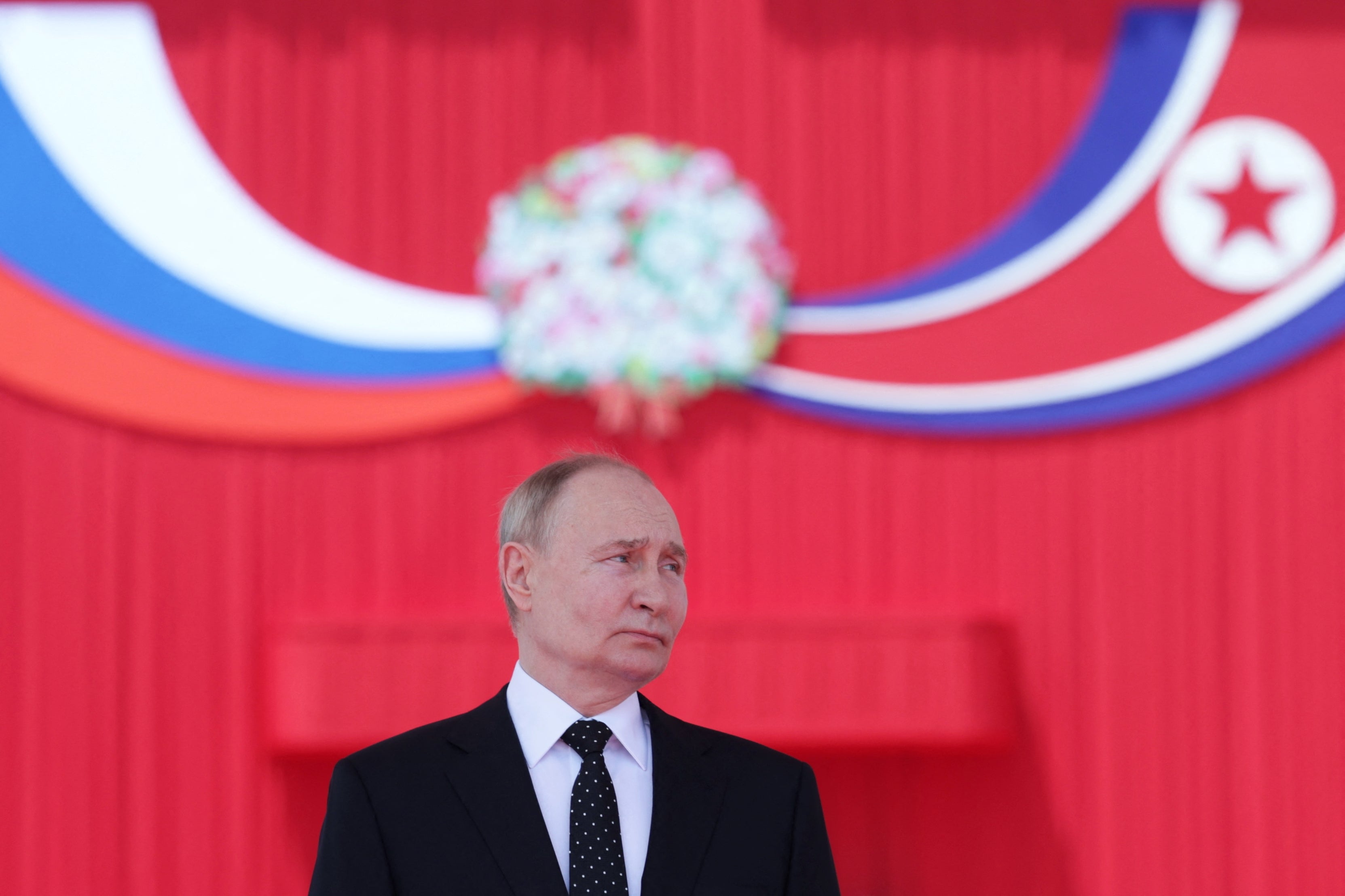 Vladimir Putin attends a welcoming ceremony at Kim Il Sung Square in Pyongyang