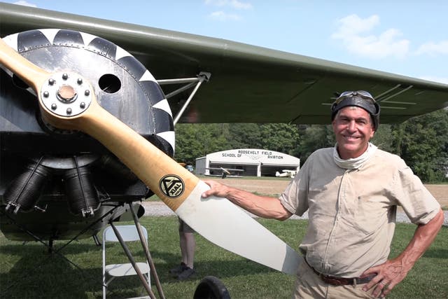 <p>Pictured: Brian Coughlin,60,  standing with the Fokker DVIII replica aircraft </p>