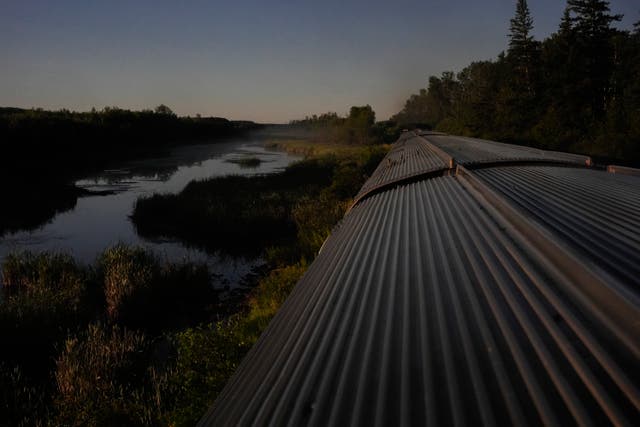 <p>A train travels through remote wilderness Saturday, August 10, 2024, near Canora, Saskatchewan</p>