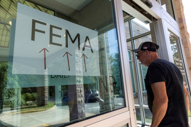 <p>A man enters a FEMA station in western North Carolina on Saturday. FEMA has provided more than $210 million to survivors of Hurricane Helene across six Southeast states, but the agency faces dwindling funding and political rumors</p>