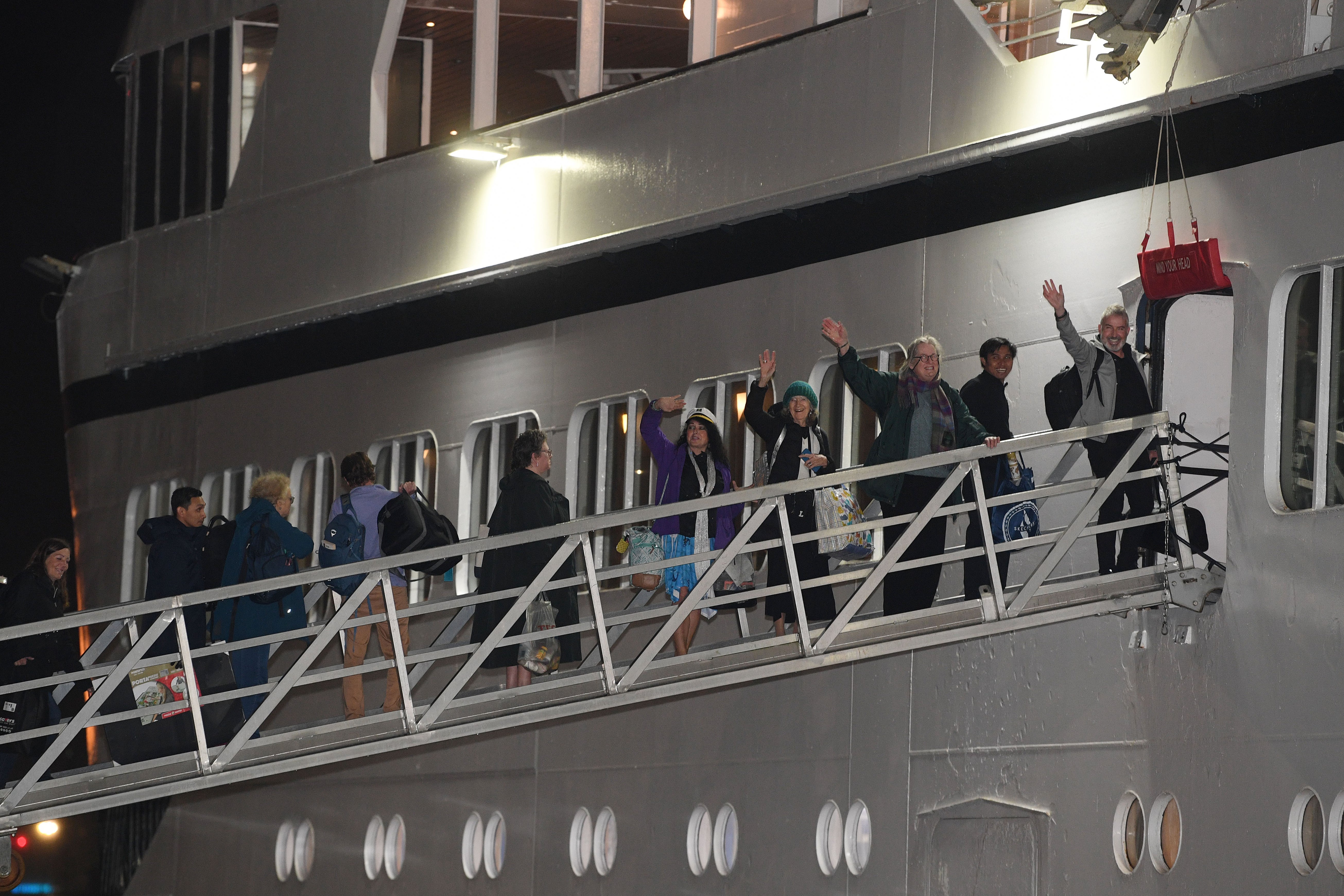 Passengers wave as they finally make their way onto Odyssey