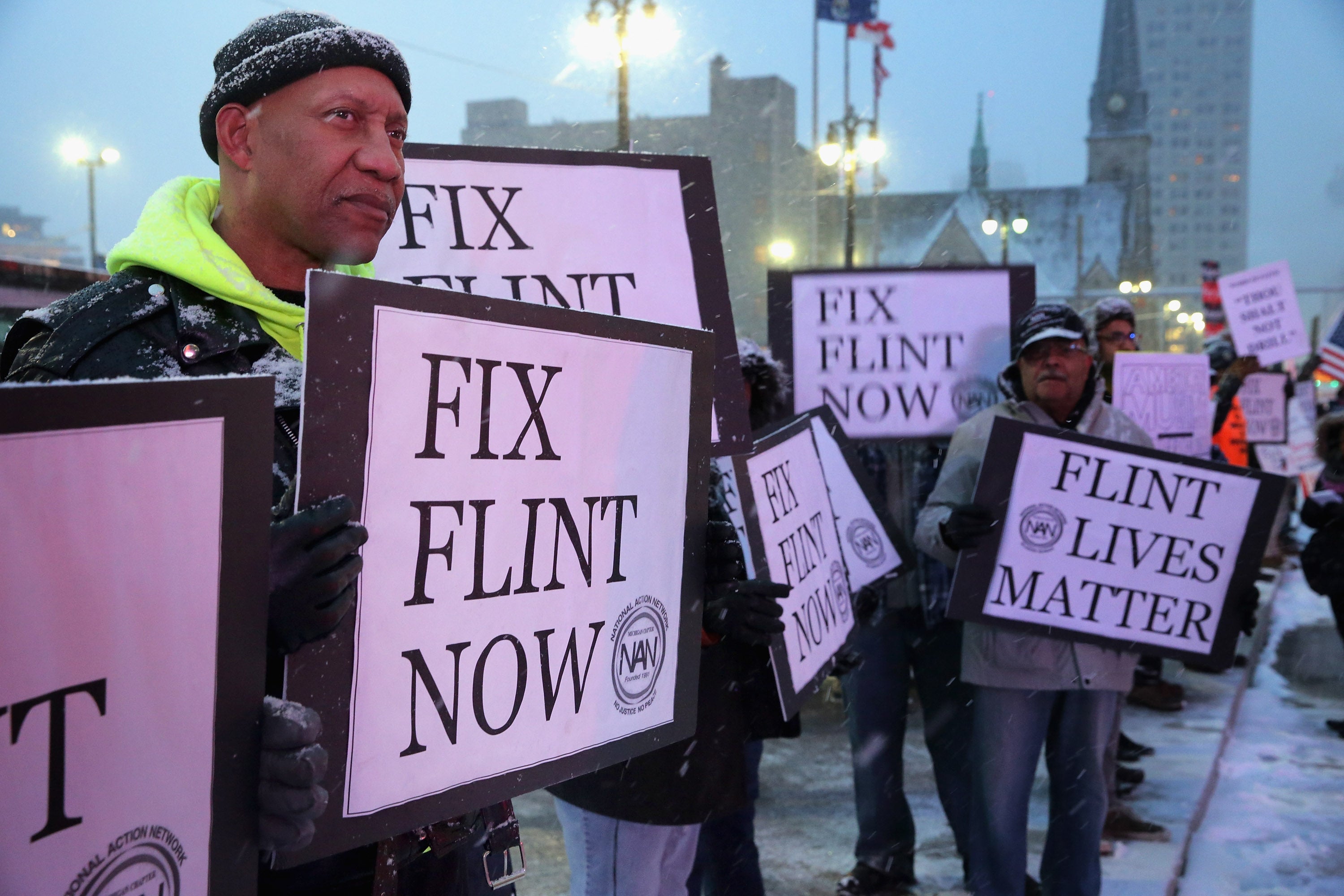 Demonstrators hold signs that read, “Fix Flint Now” in 2016, two years after the Flint, Michigan, water crisis began. Lead exposure can lead to serious health conditions in children, including damage to the nervous system