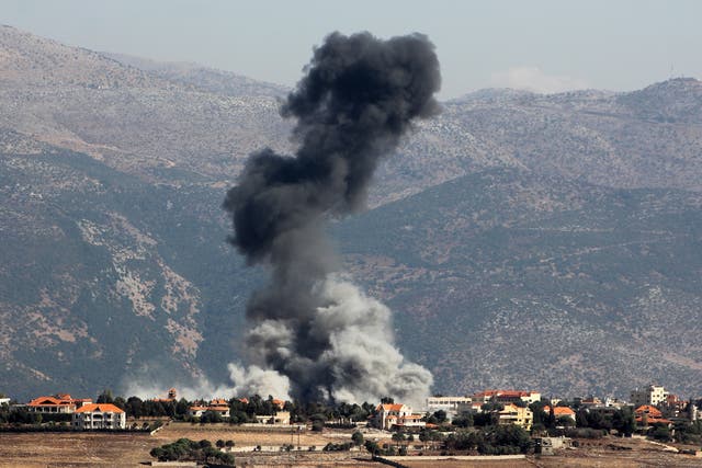 <p>A plume of smoke billows following an Israeli airstrike on the village of Khiam in southern Lebanon</p>