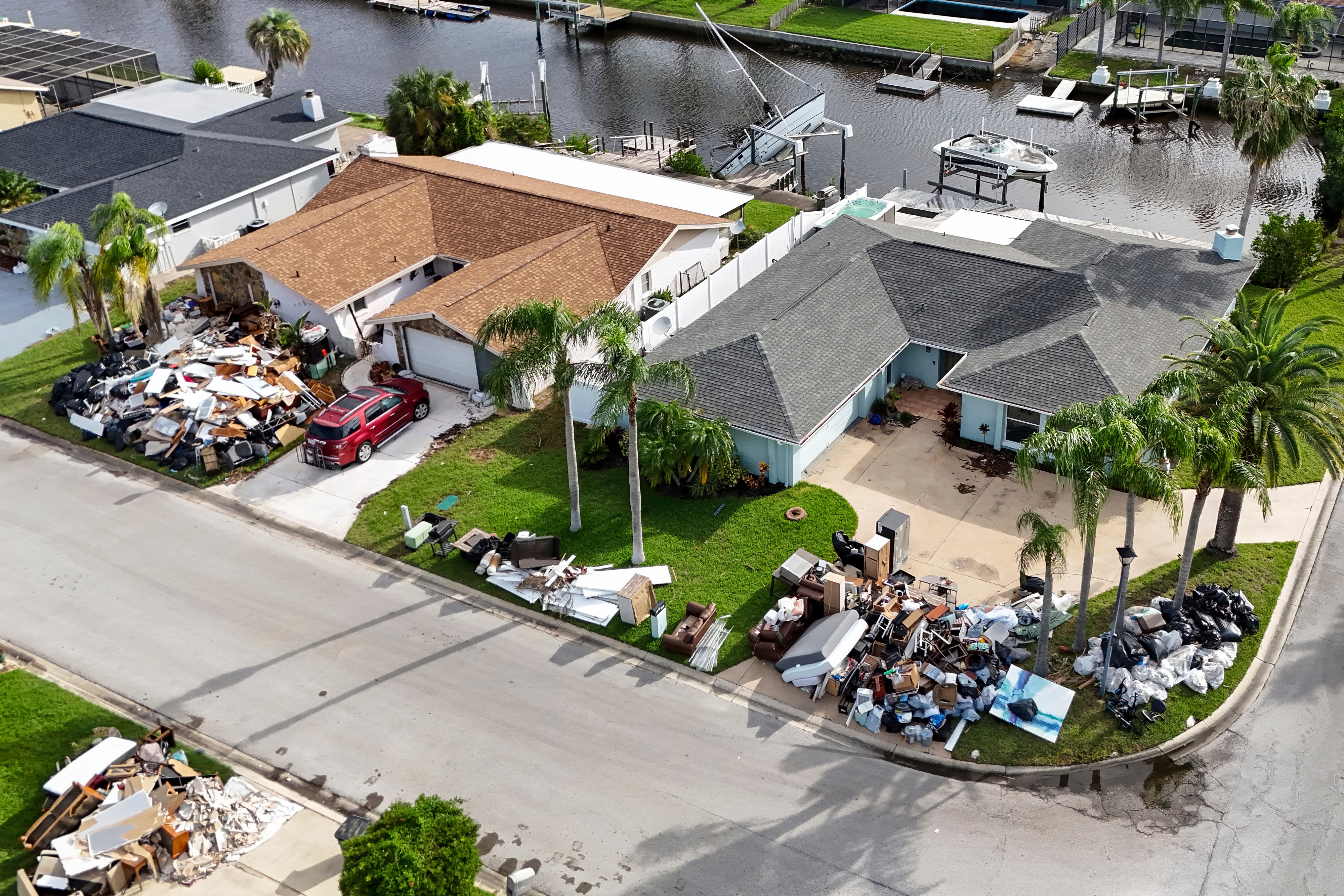 Debris from homes flooded in Hurricane Helene is piled curbside in Port Richey, Florida, on Tuesday, as Hurricane Milton approaches. The state was working to clear as much debris as it could before Milton hits.