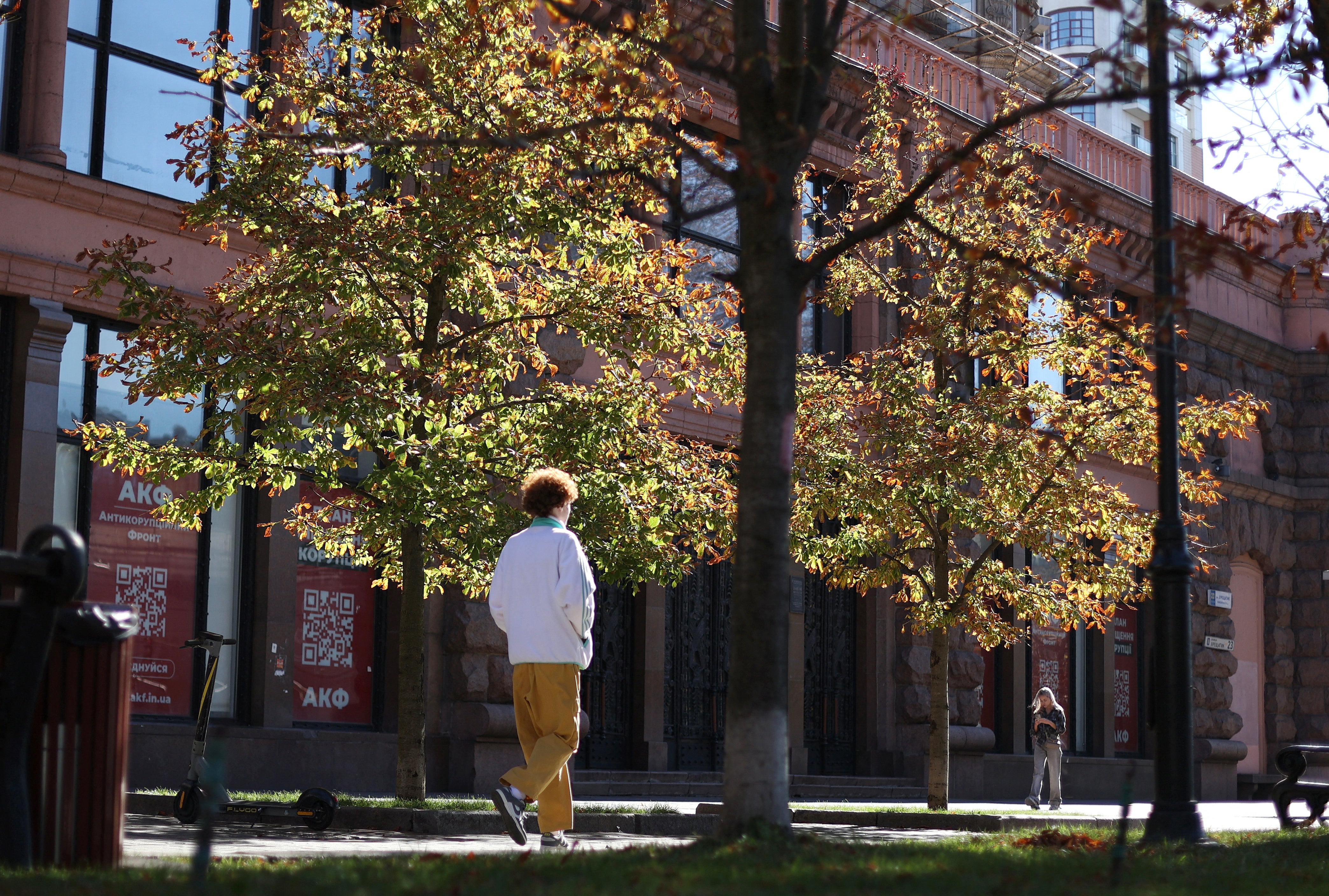 A man crosses local park in central Kyiv amid the Russian invasion