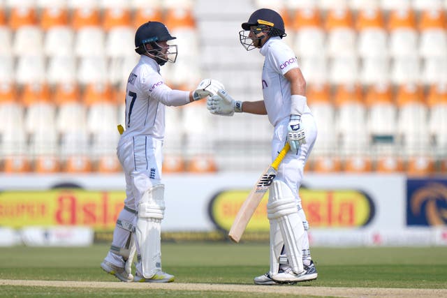 England’s Ben Duckett, left, and Joe Root bump their fists to celebrate (Anjum Naveed/AP)