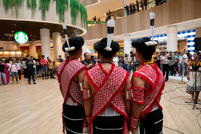 <p>Artists from India’s northeastern state of Nagaland wearing traditional attire perform for a performance</p>