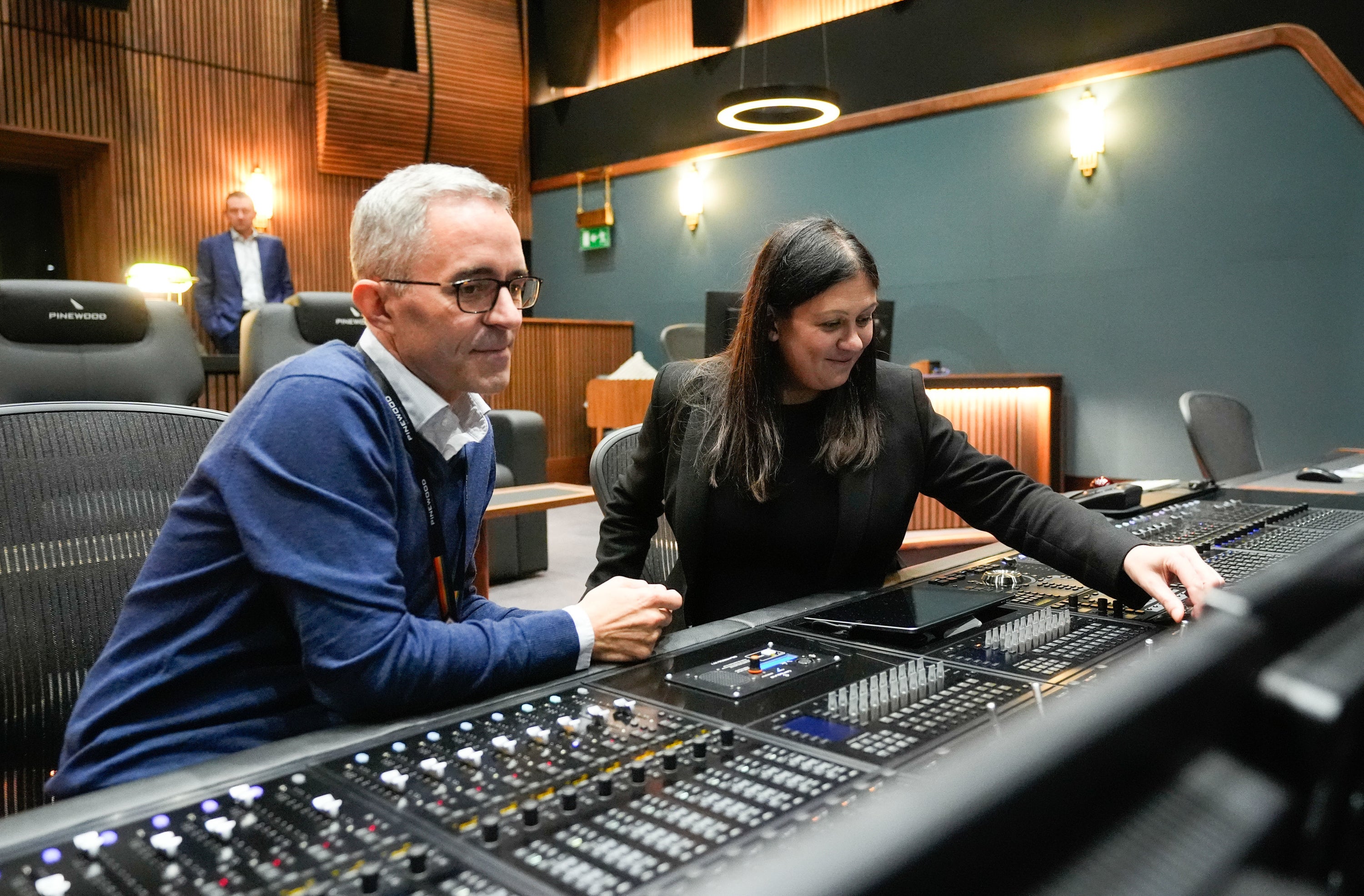 Culture Secretary Lisa Nandy (right) is shown a sound mixing desk by Jens Christensen, Post Production Director, Pinewood Group