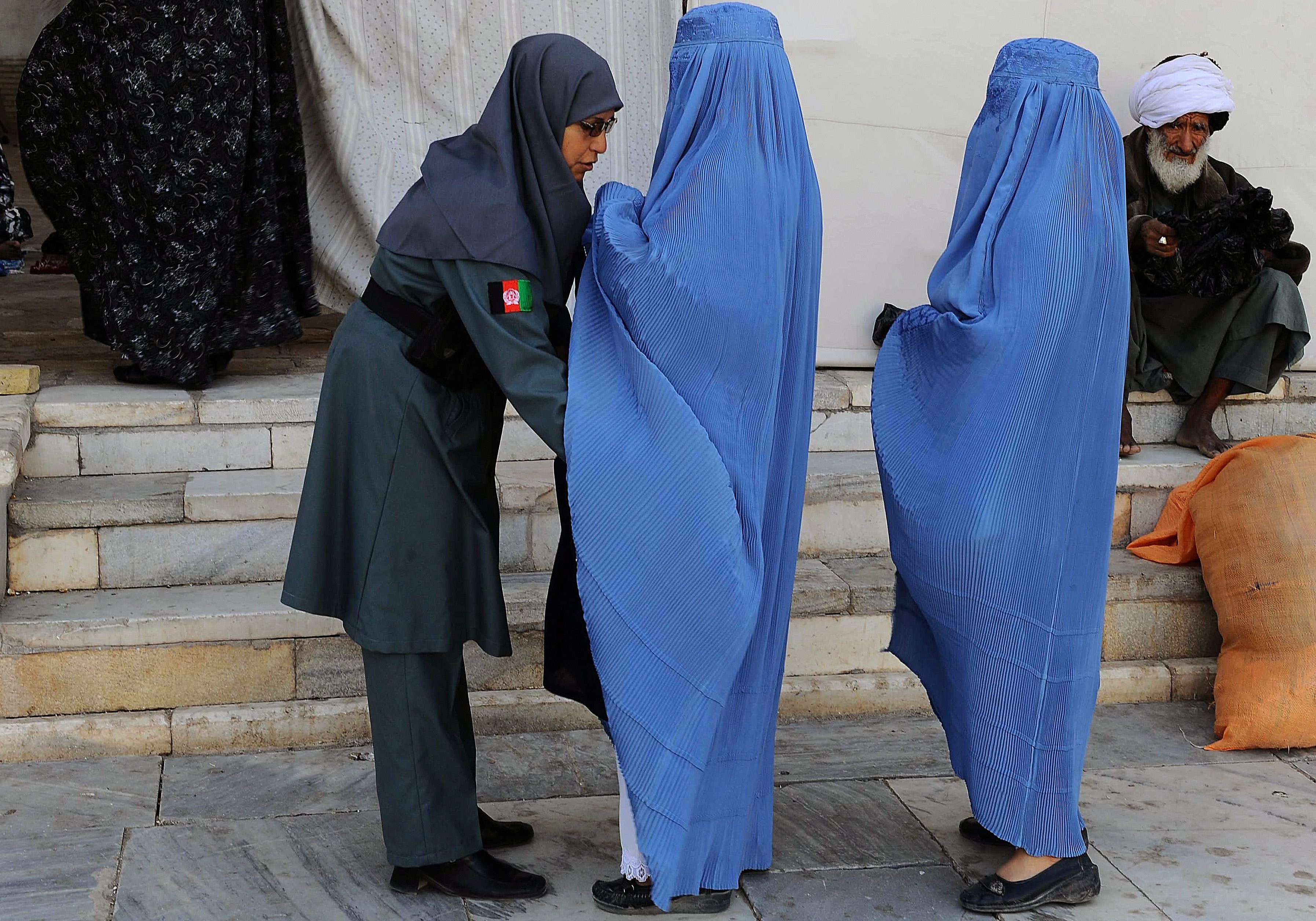 An Afghan policewoman searches worshippers arriving for Eid prayers successful  Herat successful  2013