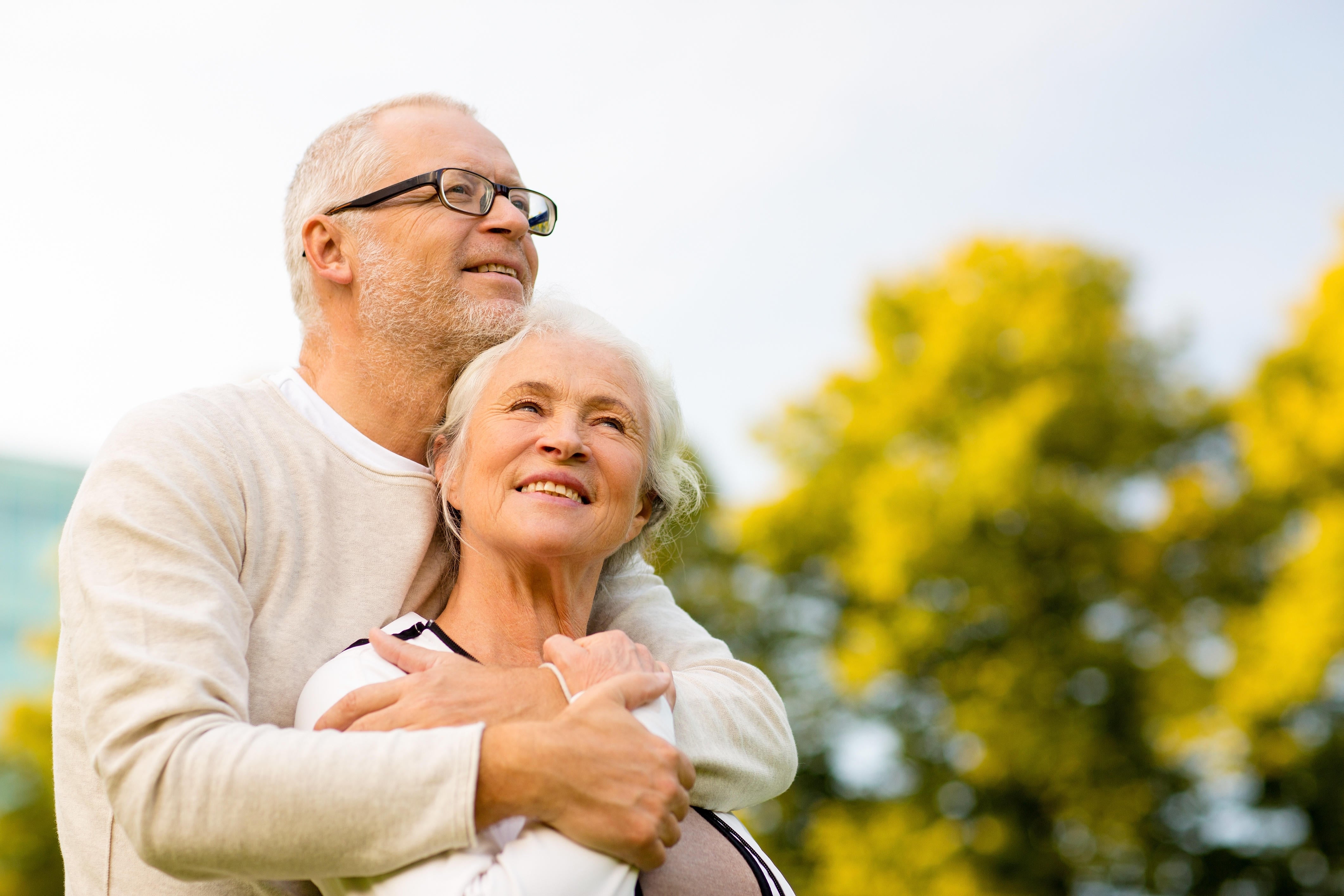 A Senior couple hugging in the park