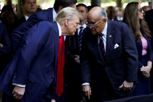 <p>Donald Trump speaks with his former attorney Rudy Giuliani during a September 11 memorial. </p>
