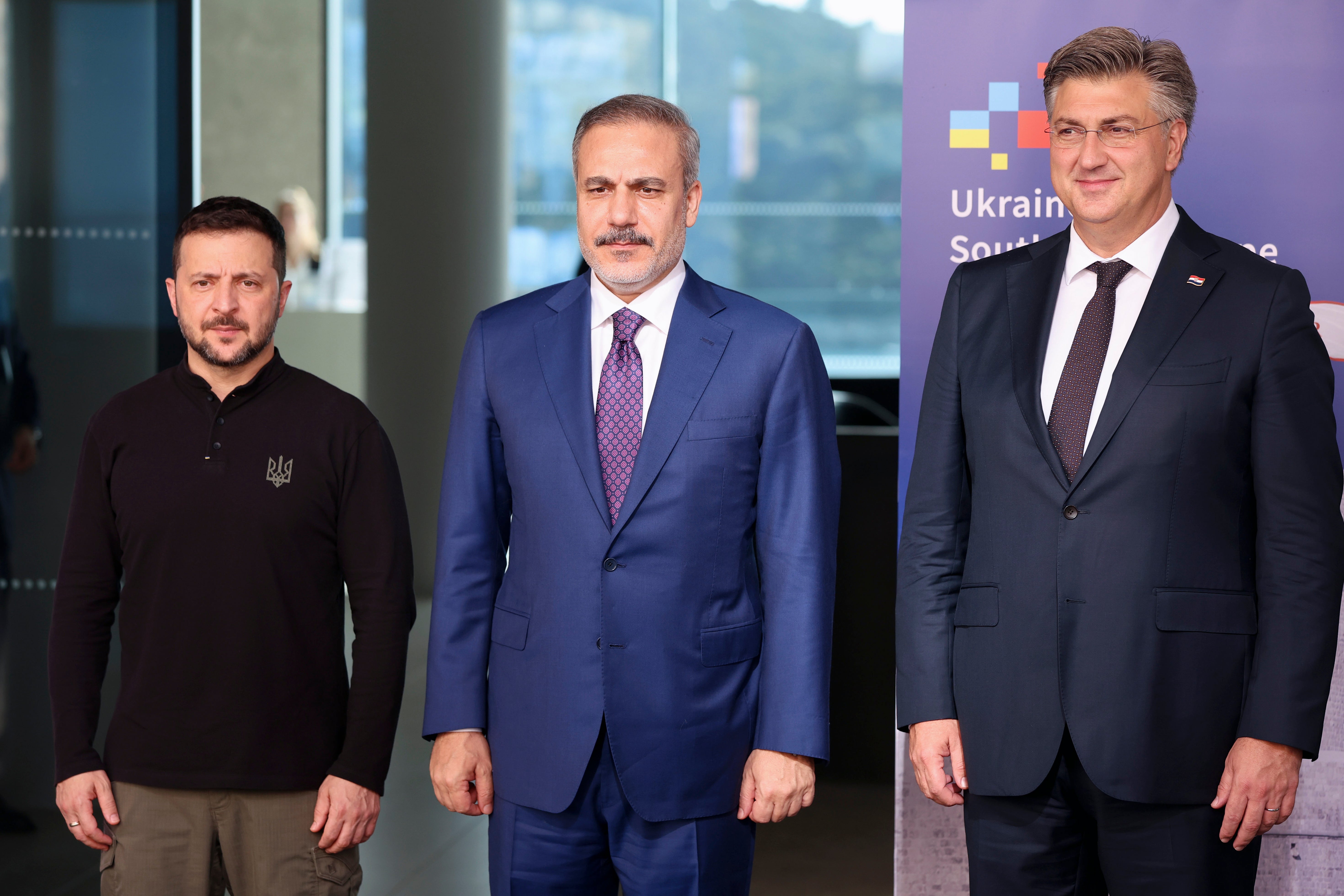 Ukrainian President Volodymyr Zelenskyy, left, and Croatian Prime Minister Andrej Plenkovic, right, pose with Turkish Foreign Minister Hakan Fidan, center, during the Southeast Europe Croatia Ukraine summit in Dubrovnik, Croatia