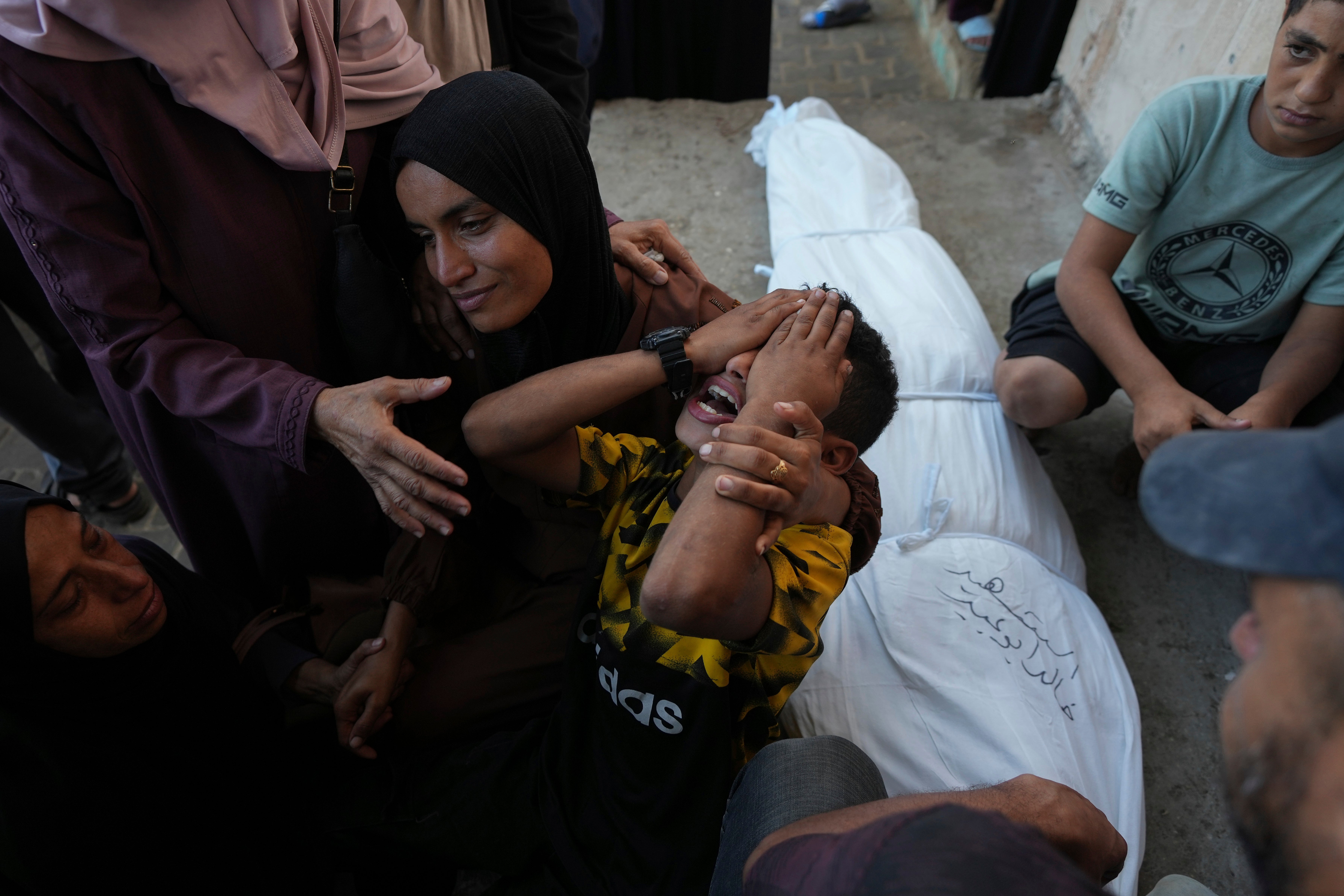 Mourners attend the funeral of Palestinians killed in the Israeli bombardment