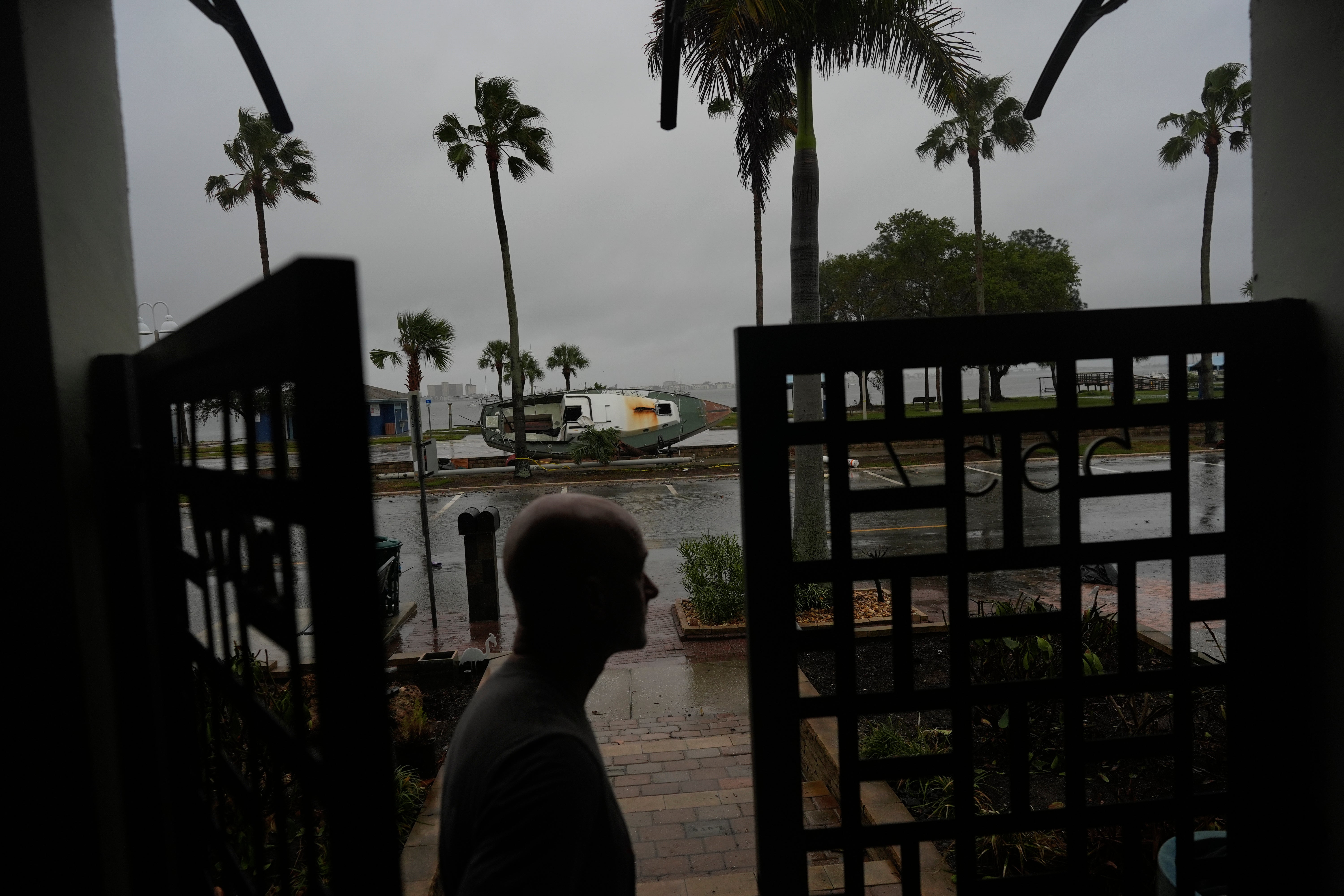 Christian Burke stands at the door of his Gulfport, Florida home, where he, his mother, and his aunt plan to ride out Hurricane Milton on Wednesday.