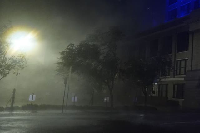 Wind-driven rain soaks a street in downtown Tampa, (Rebecca Blackwell/AP)
