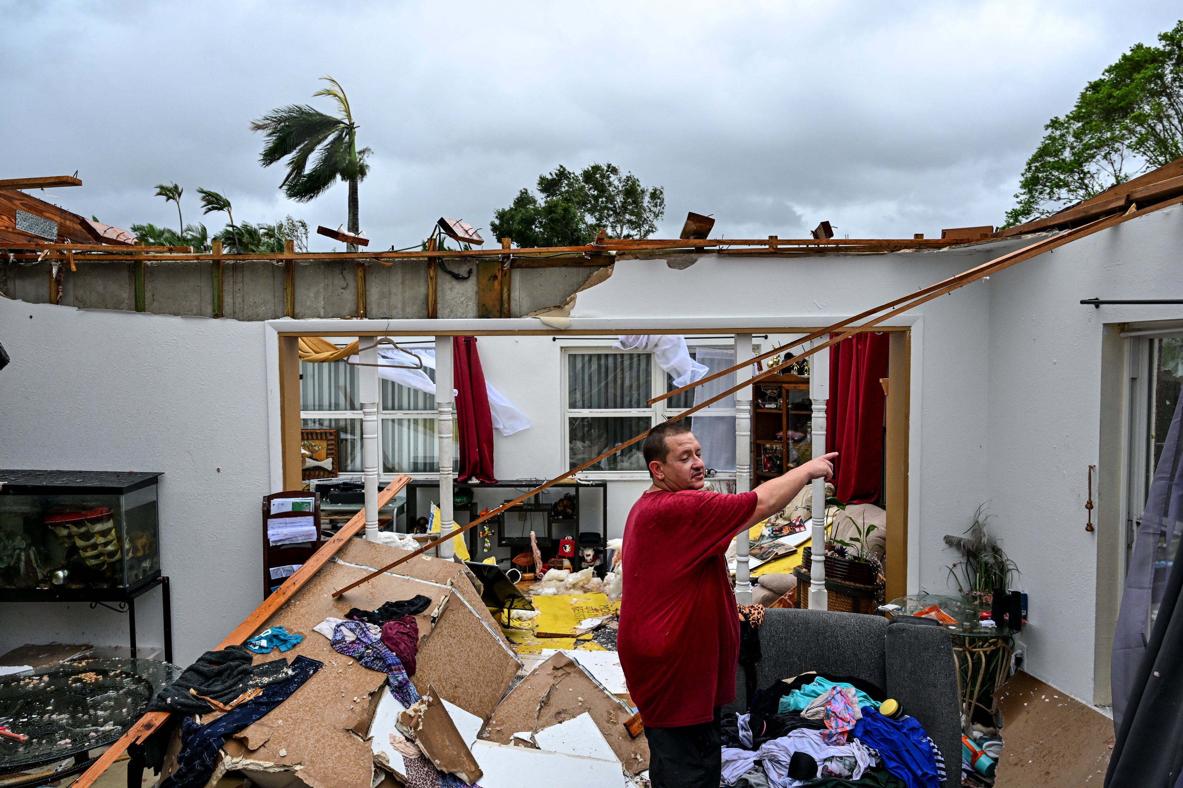 Robert Haight looks around his destroyed house after it was hit by a reported tornado in Fort Myers