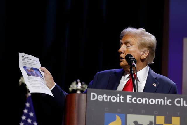 <p>Donald Trump held up a printed version of an article and incorrectly claimed he was named ‘Man of the Year’ at the Detroit Economic Club  </p>