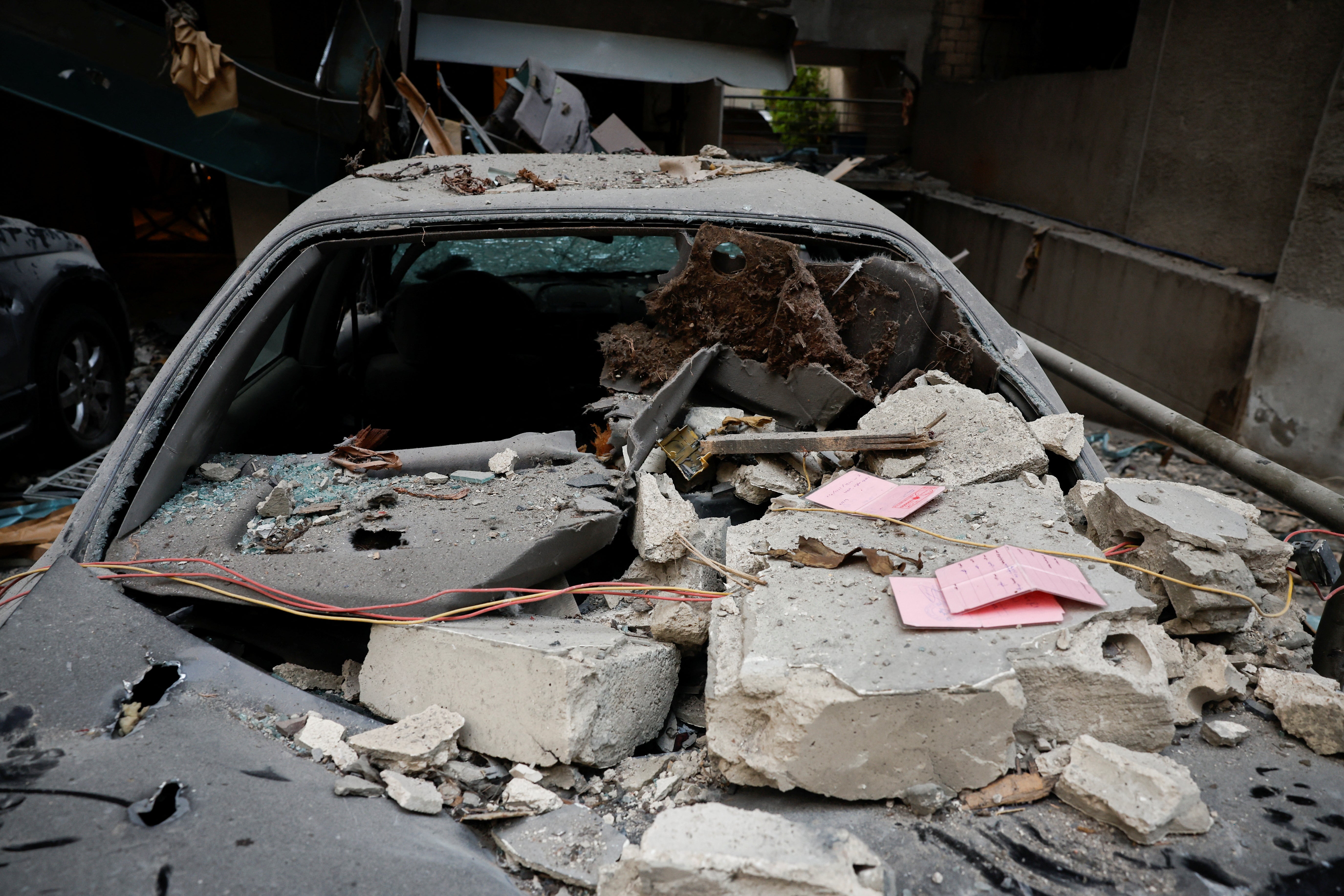 Rubble lies on top of a damaged vehicle at the site of an Israeli air strike in Beirut