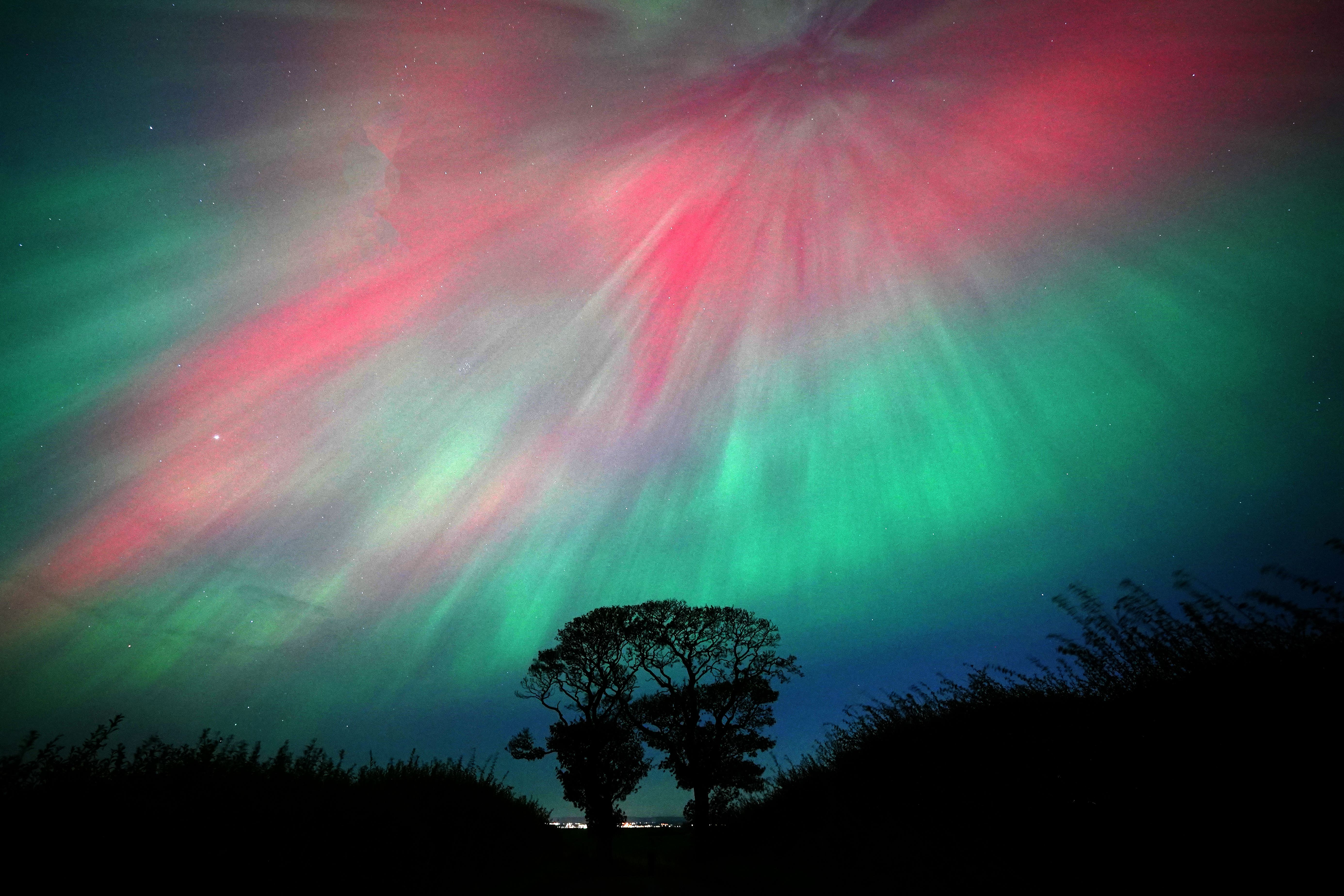 The aurora borealis lit up the skies above The Kissing Trees near Kinghorn in Fife (PA)