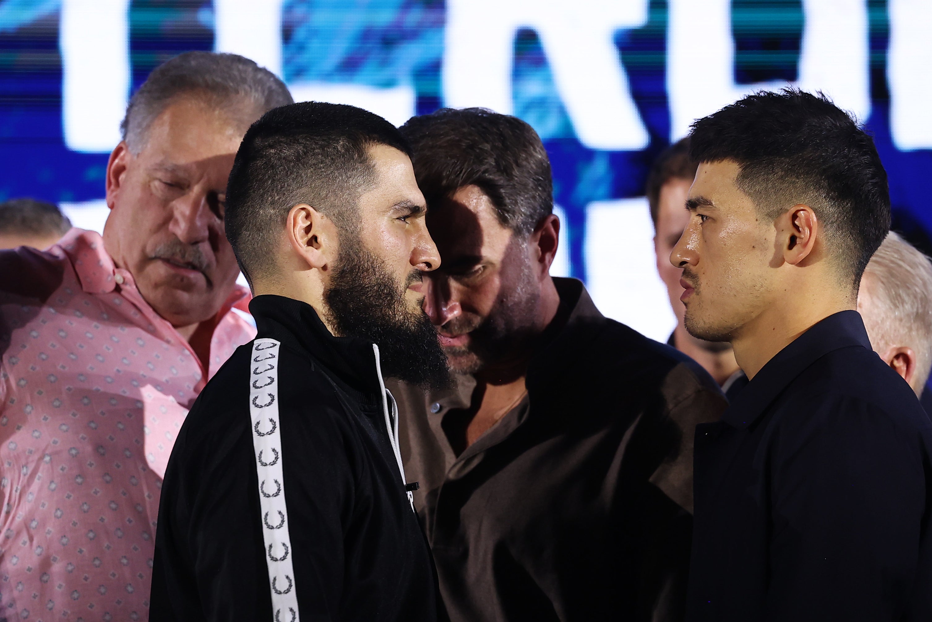 Eddie Hearn (centre) tried to rile up Artur Beterbiev (centre-left) during the press conference