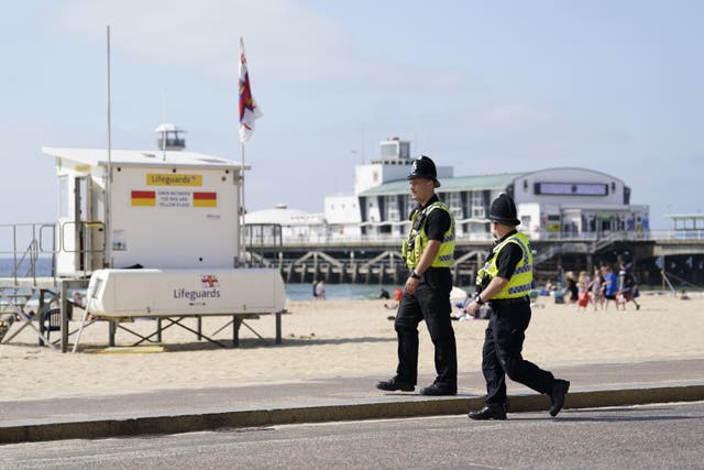 Police officers walk along Bournemouth beach after the incident in May (Andrew Matthews/PA)