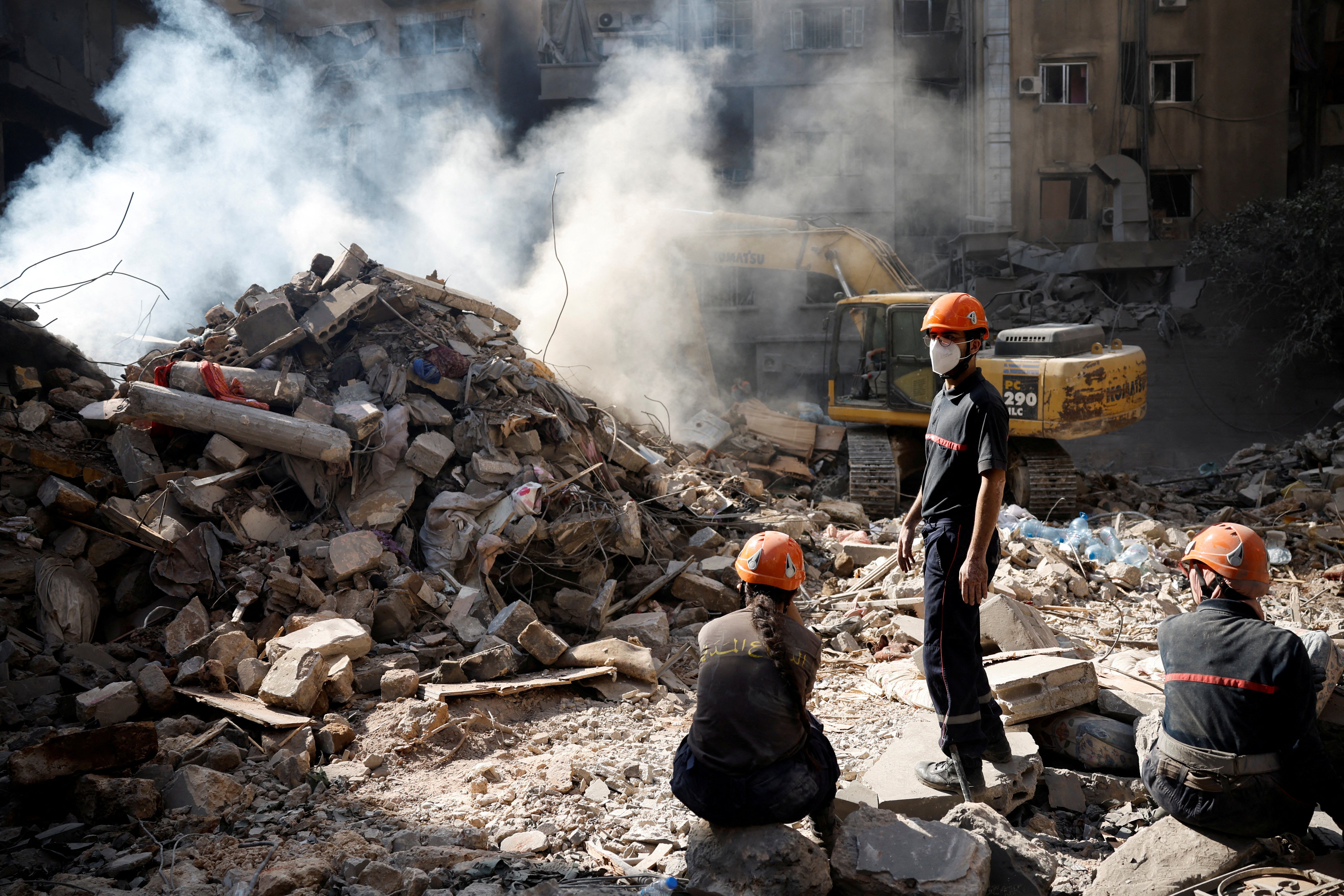 Emergency personnel work at the site of an Israeli air strike, amid ongoing hostilities between Hezbollah and Israeli forces, in Beirut, Lebanon