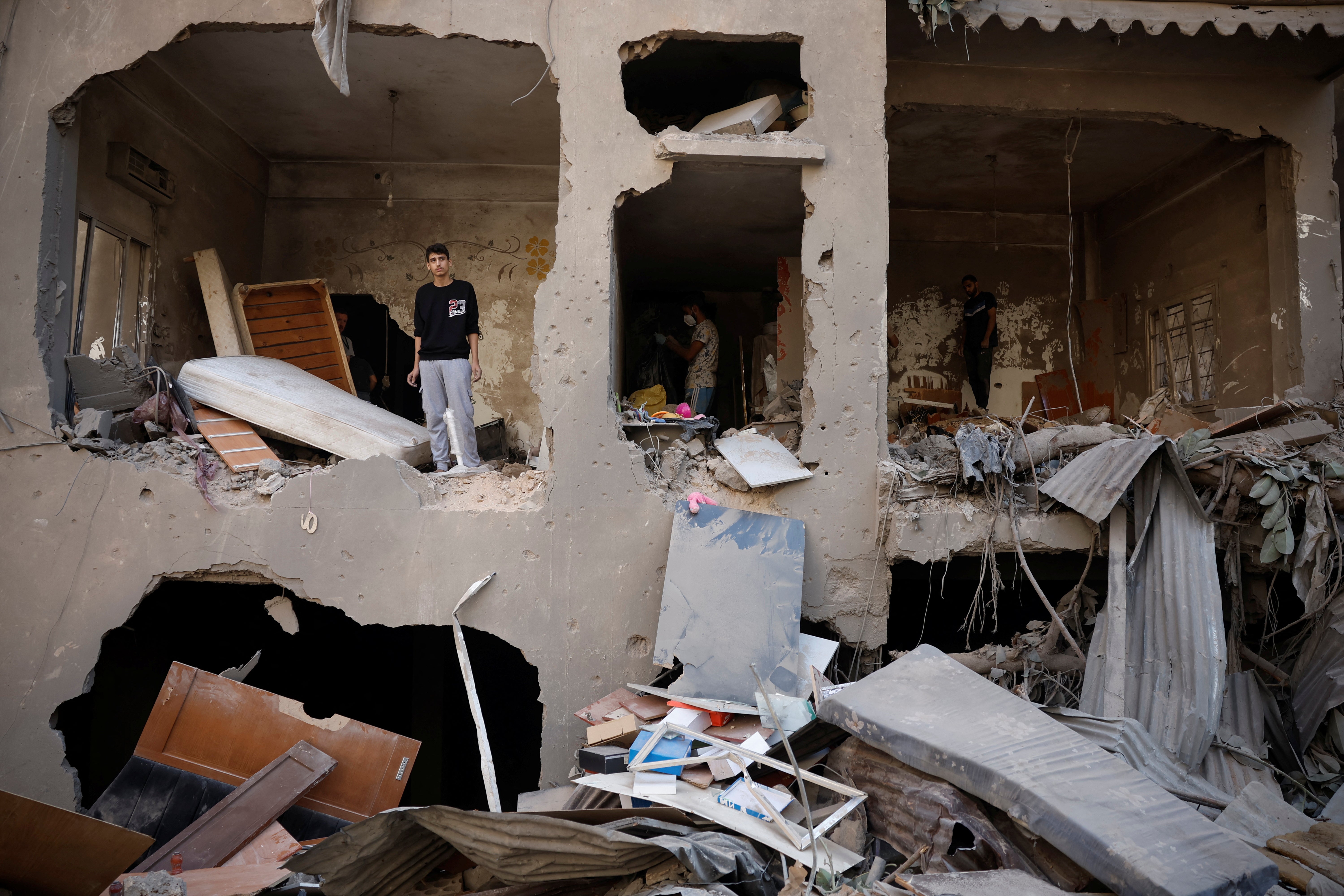 A man stands in the damaged apartment of Ahmed Al-Khatib at the strike site in Beirut